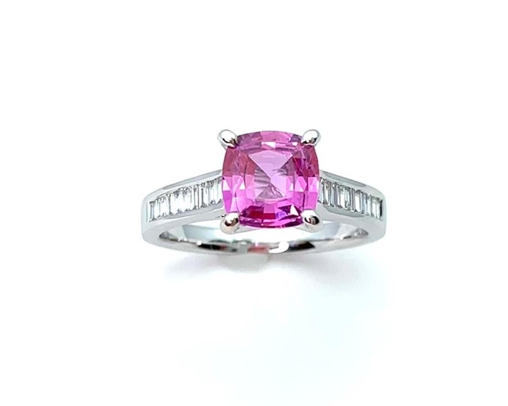 This lovely sapphire and diamond ring features a timeless design set with a beautifully vibrant, bright rose pink sapphire weighing 1.78 carats. An extremely brilliant and lively gem that pairs flawlessly with channel-set baguette-cut diamonds on