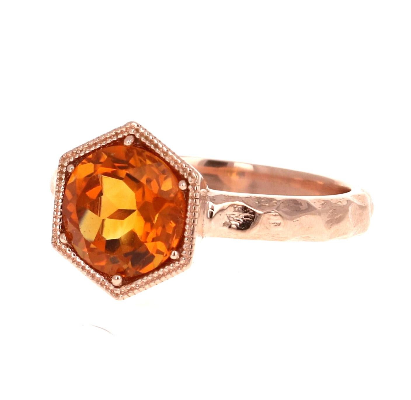 This beautiful and simple ring has a bright and vivid Round Cut Citrine Quartz in the center that weighs 1.78 carats. 
It is set in a beautifully crafted hammered style 14 Karat Rose Gold setting and weighs approximately 3.9 grams.
The ring is a