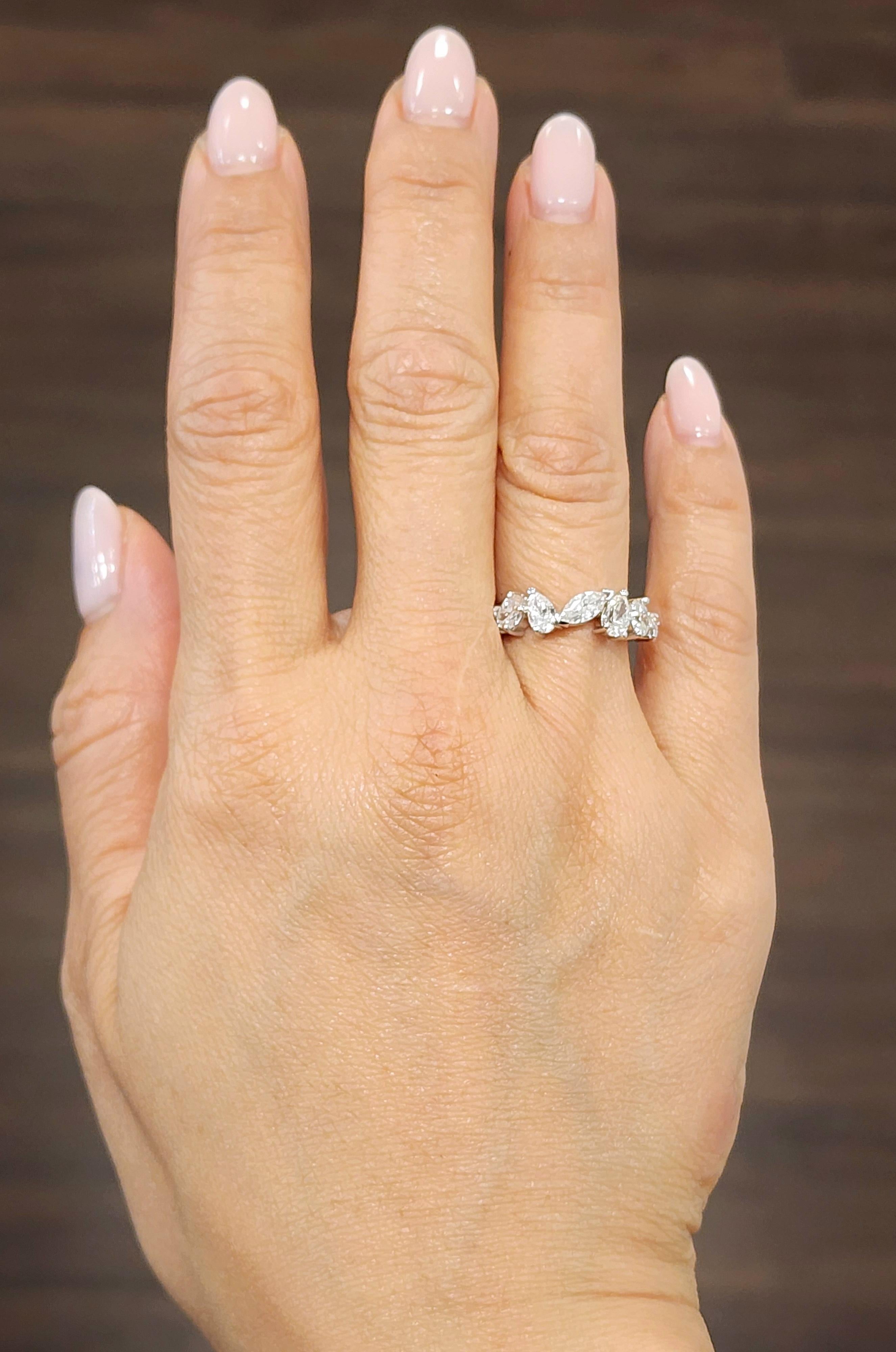 This gorgeous mixed shaped diamond ring features 7 different shaped diamonds half way around the band. The diamonds showcase a color of F/G and VS1/VS2 in clarity and encased in 18k white gold. A beautiful ring to add to anyone's jewelry collection.