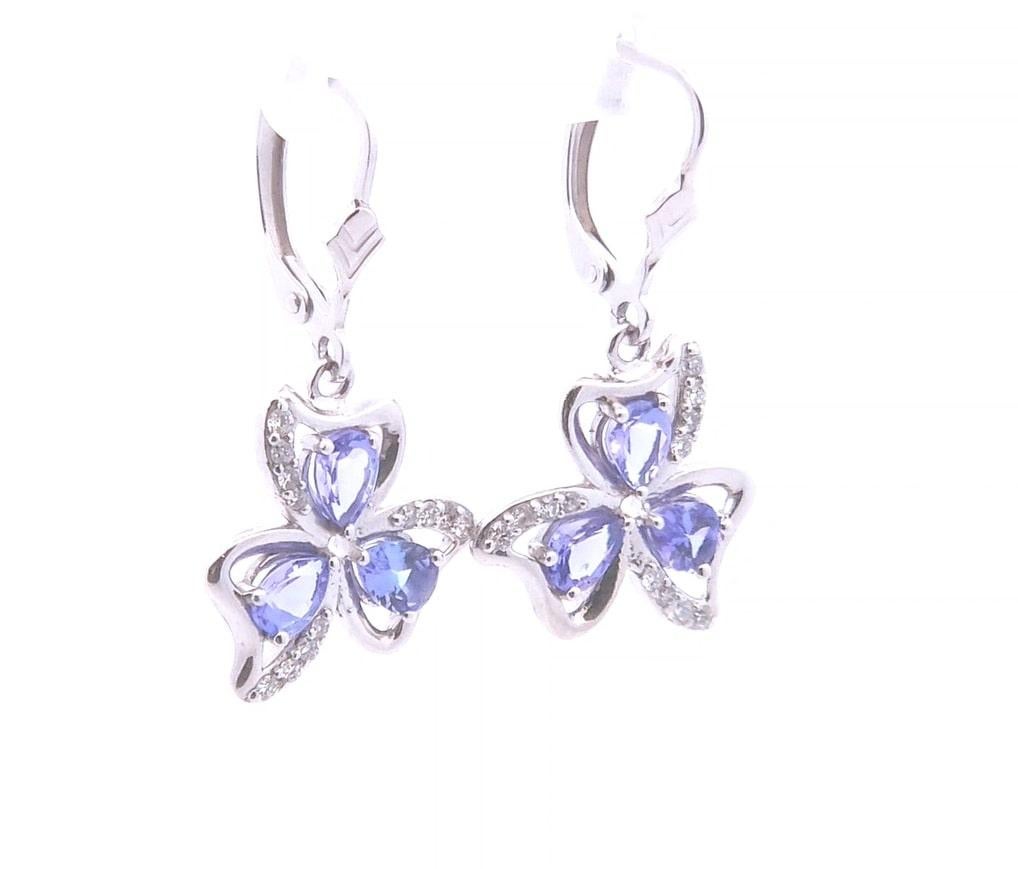 Quality, at the right price.

These designer lever-back earrings feature a total carat weight of 2.06. These earrings have 1.78 of pear cut tanzanite. These earrings also have 0.28 carats of round diamonds surrounding the gemstone in the shape of a