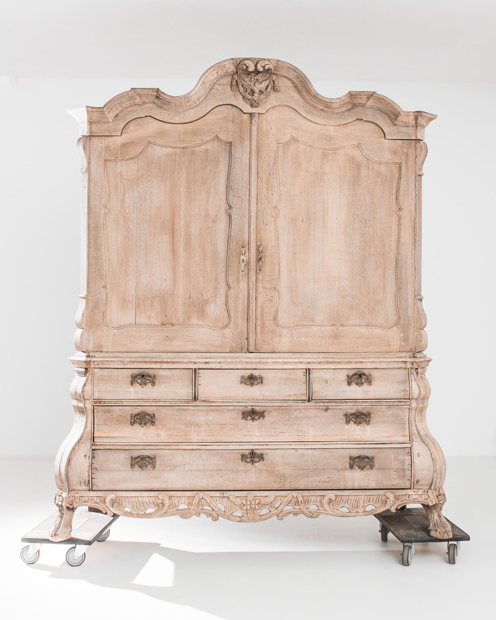 Transport your living space to the refined elegance of the 1780s with the Dutch Bleached Oak Cabinet. Its luminous light oak finish infuses a timeless charm, while the two main doors open to reveal a capacious interior, unadorned with shelves,