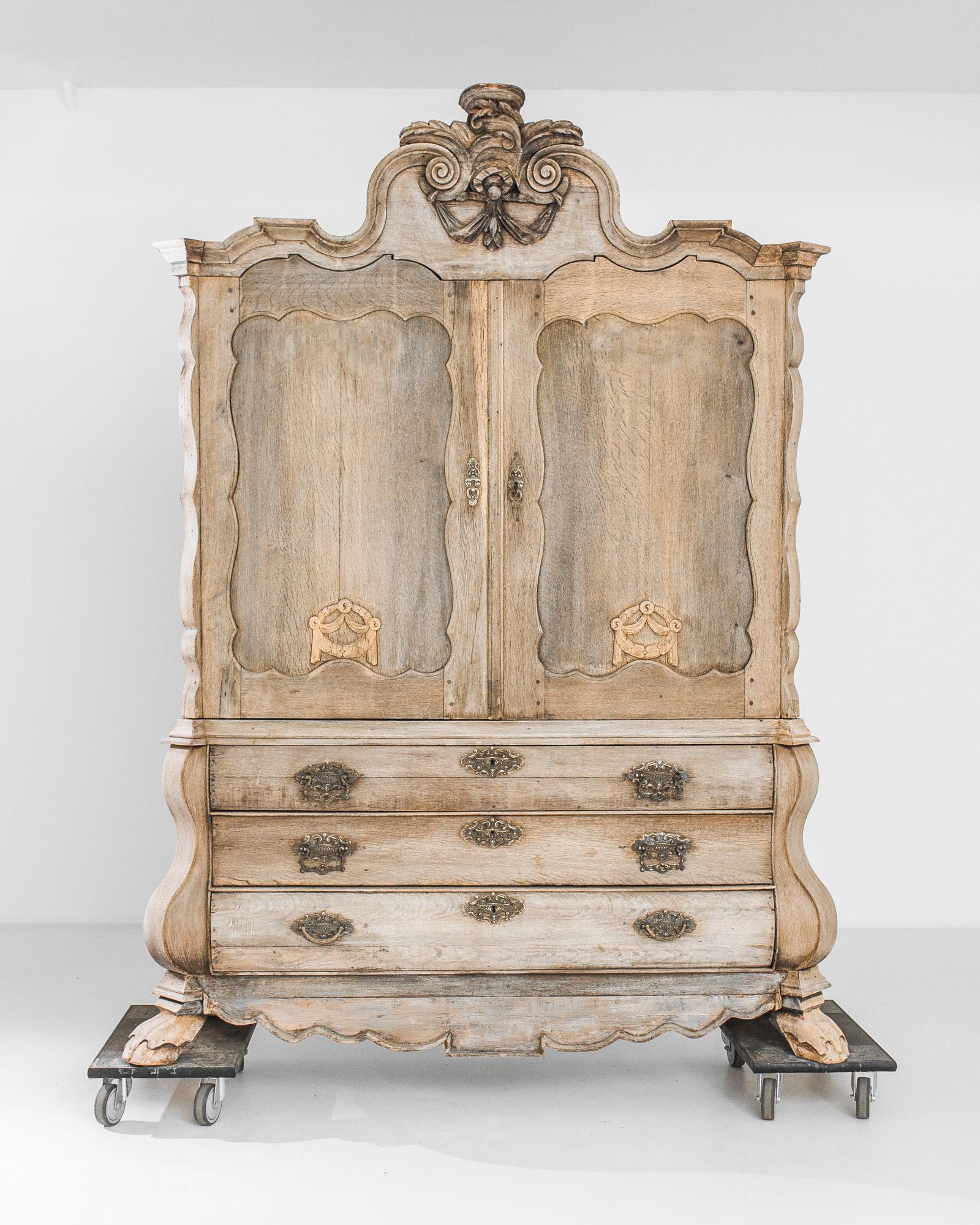 Indulge in the opulence of the 1780s with the Dutch Bleached Oak Cabinet, a paragon of unparalleled elegance. This resplendent piece features two main doors above, complemented by three drawers below, creating a harmonious and balanced silhouette.
