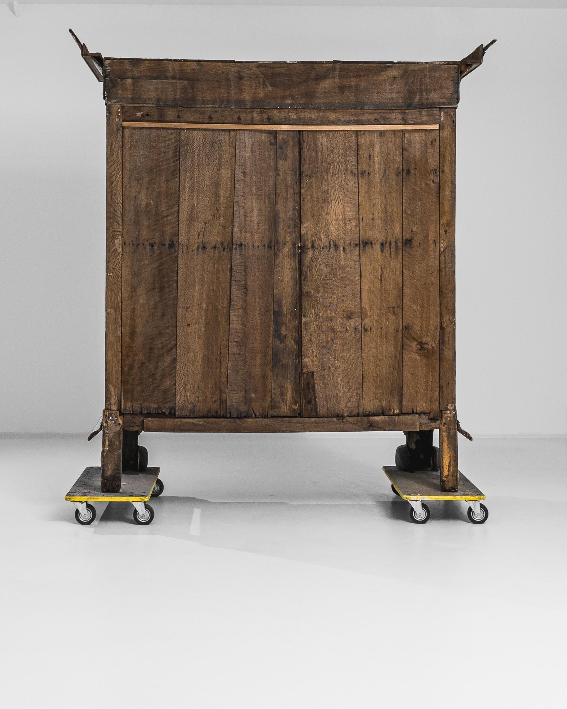 Step into the grandeur of the past with this remarkable 1780s Dutch Bleached Oak Cabinet. Standing tall and impressive, it boasts three column carvings—one on each side and one in the middle—each meticulously adorned with intricate hand-carved