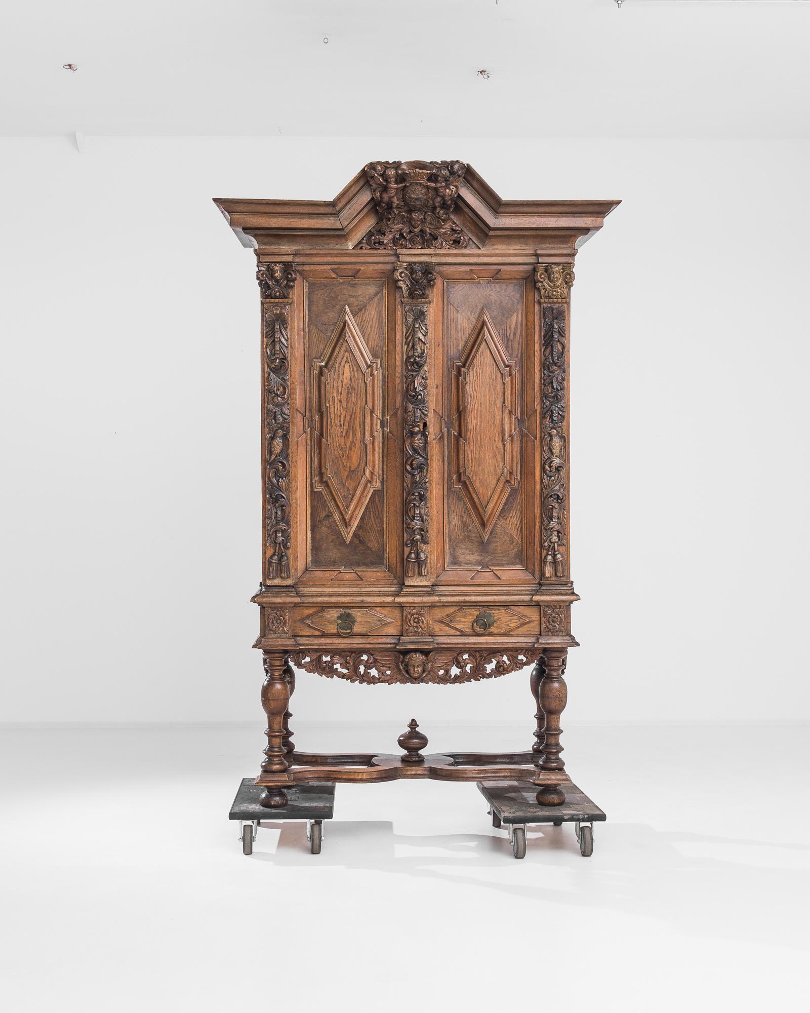 Magnificent carving makes this antique wooden cabinet a truly covetable acquisition. Made in the Netherlands in the 1780s, the piece is dressed in its original finish, a vivid auburn color enlivened by a rich polish. Carved cherubs and songbirds