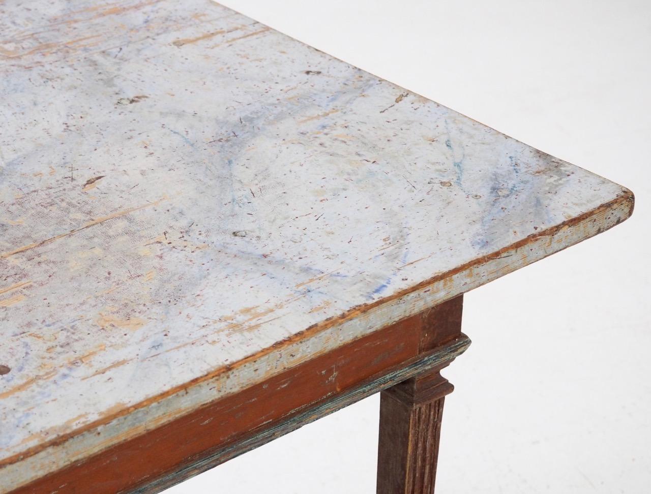 An exceptional 1780s-1790s original painted Gustavian center table, richly carved, probably made in Stockholm. It's in a stunning original red color and faux painted marble top.