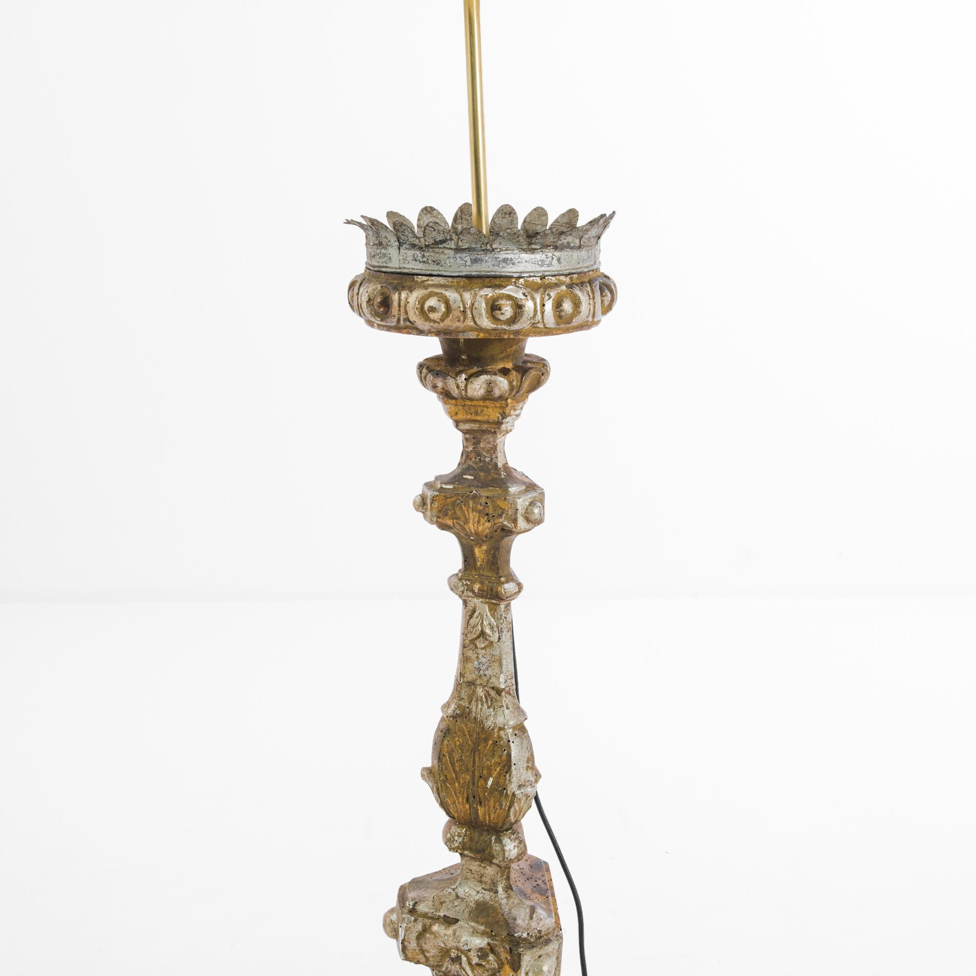 Made in France, circa 1780, this wooden floor lamp lends an old-world charm with the ornate carvings, adorned with a metal border and polychrome color. Alongside carvings of flowers and leaves, the egg and dart ornamentation as well as the scroll