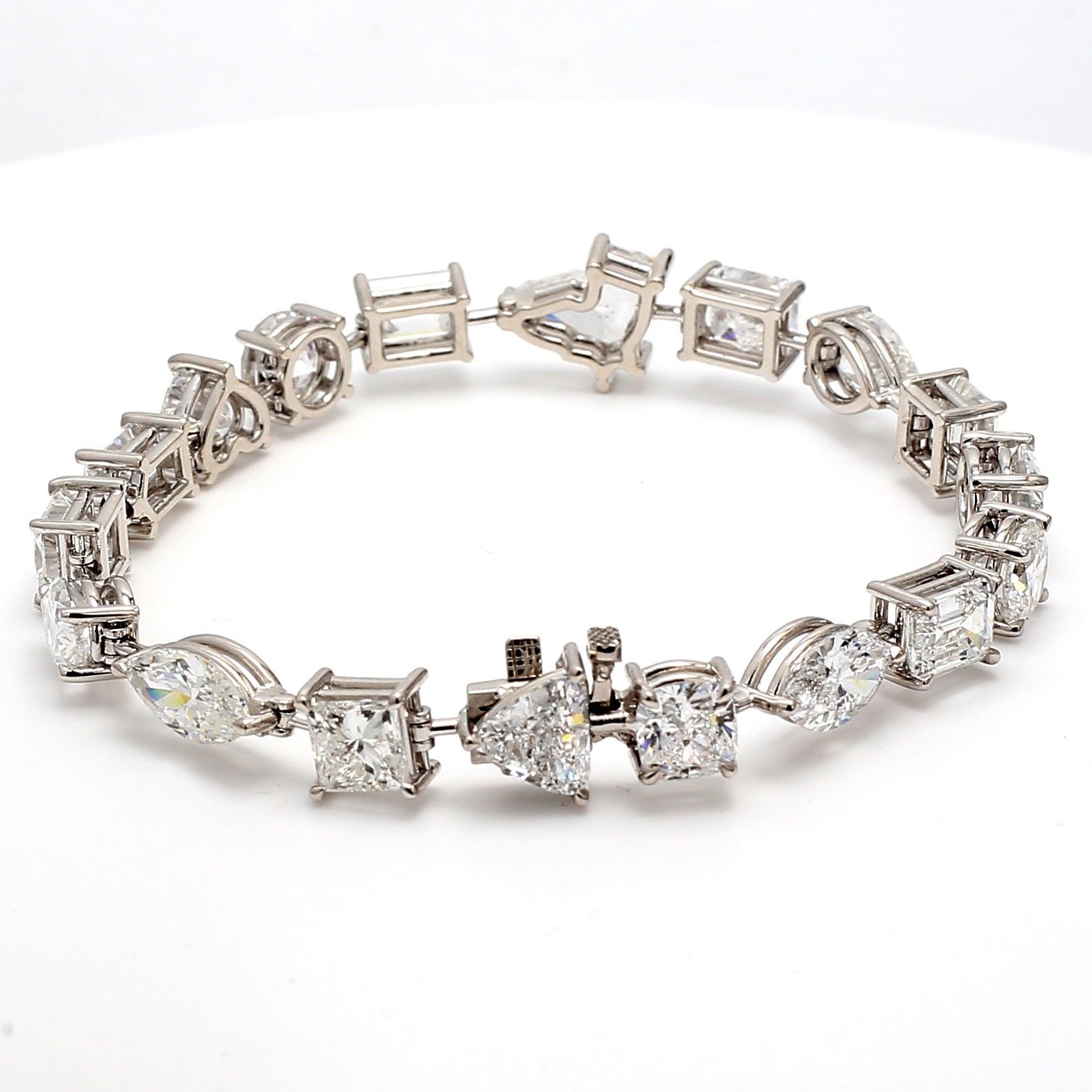 Title:
4.46 Carat Pear Shape G SI2 and Princess Cut G I1 and Asscher Cut G SI1 and Bullets Shape D SI1 and Triangular Shape D SI1 Diamond 18 Karat White Gold Tennis Bracelet


Style:
Tennis


Metal:
18 Karat White Gold


Gemstone 1:
0.78 Carat