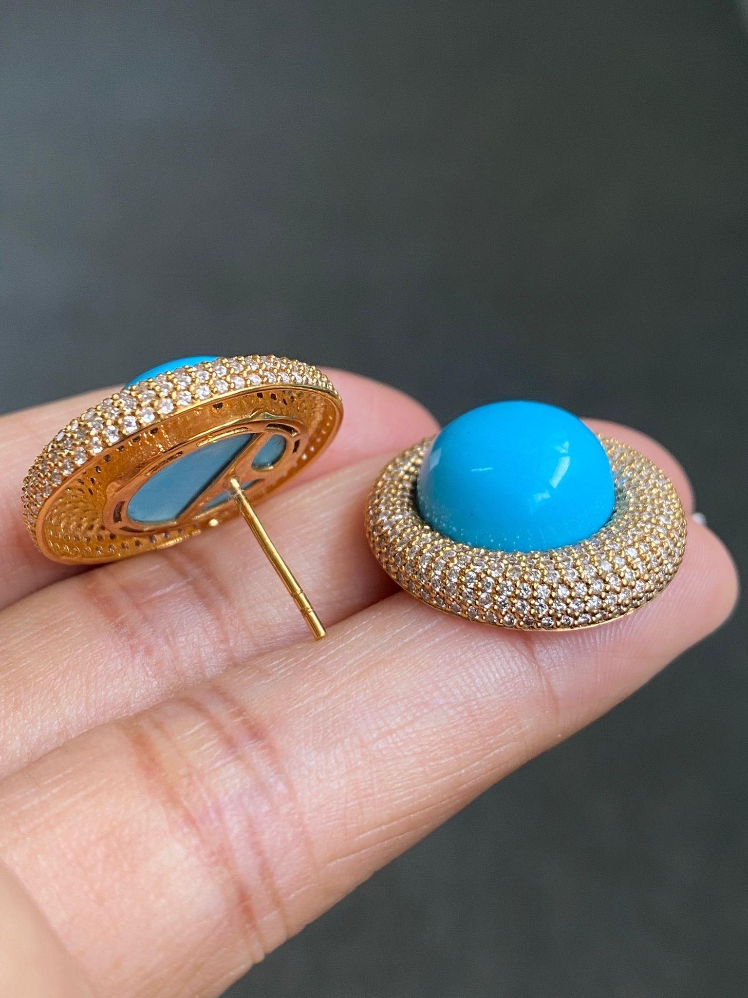 A stunning pair of vintage inspired 17.84 carat round cabochon shaped Turquoise and 3.16 carat White Diamond stud earrings set is solid 18K Yellow Gold. Comes with a push pull backing.
This pair of earrings are a perfect accessory for any and every