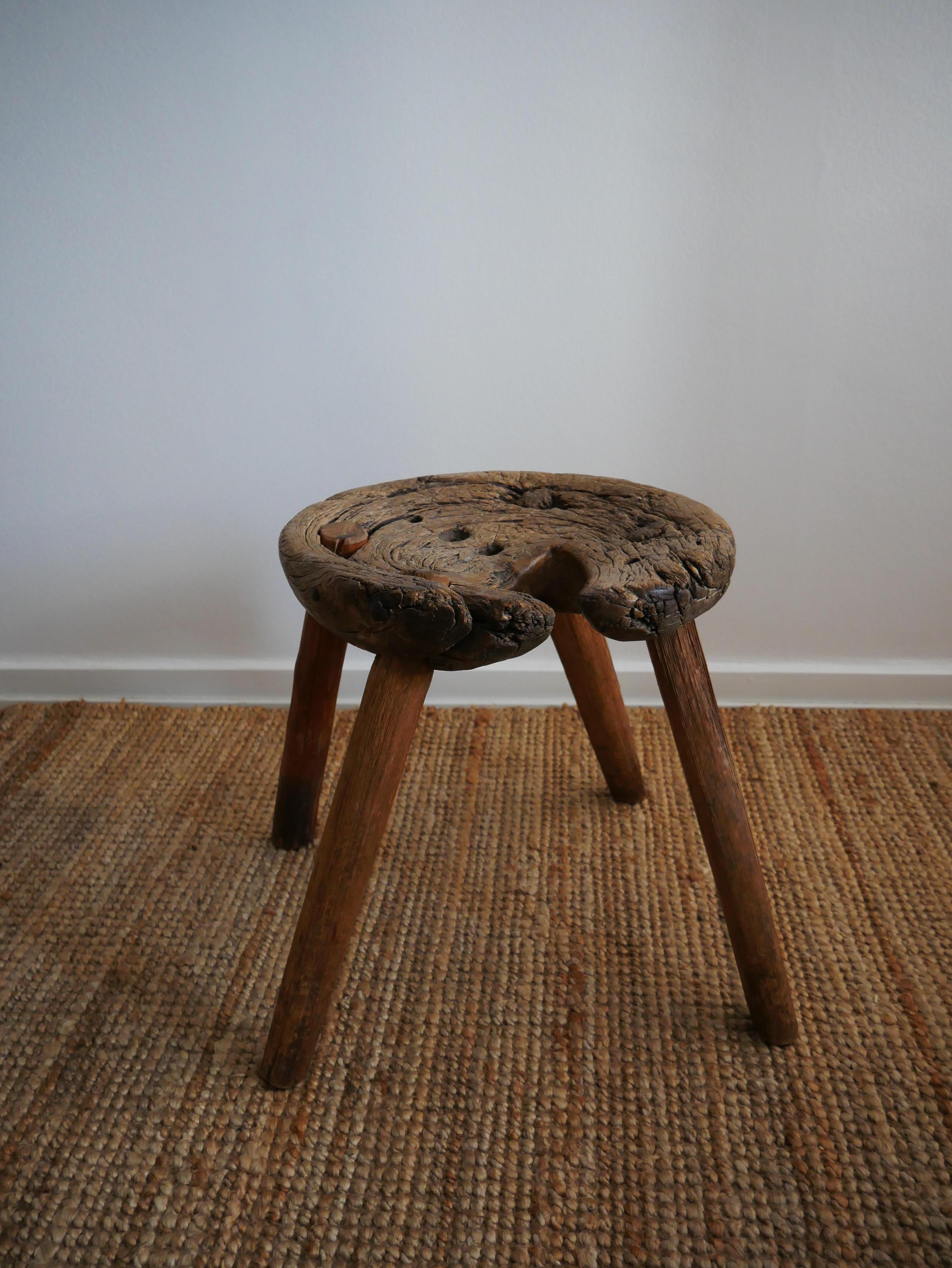 The patina of this Swedish milking stool from 1784 is amazing and truly something out of the ordinary. 
This pine sculptural wabi-sabi milking stool whit its organic form, has specifically been chosen in the woods for its shape and size.
Through