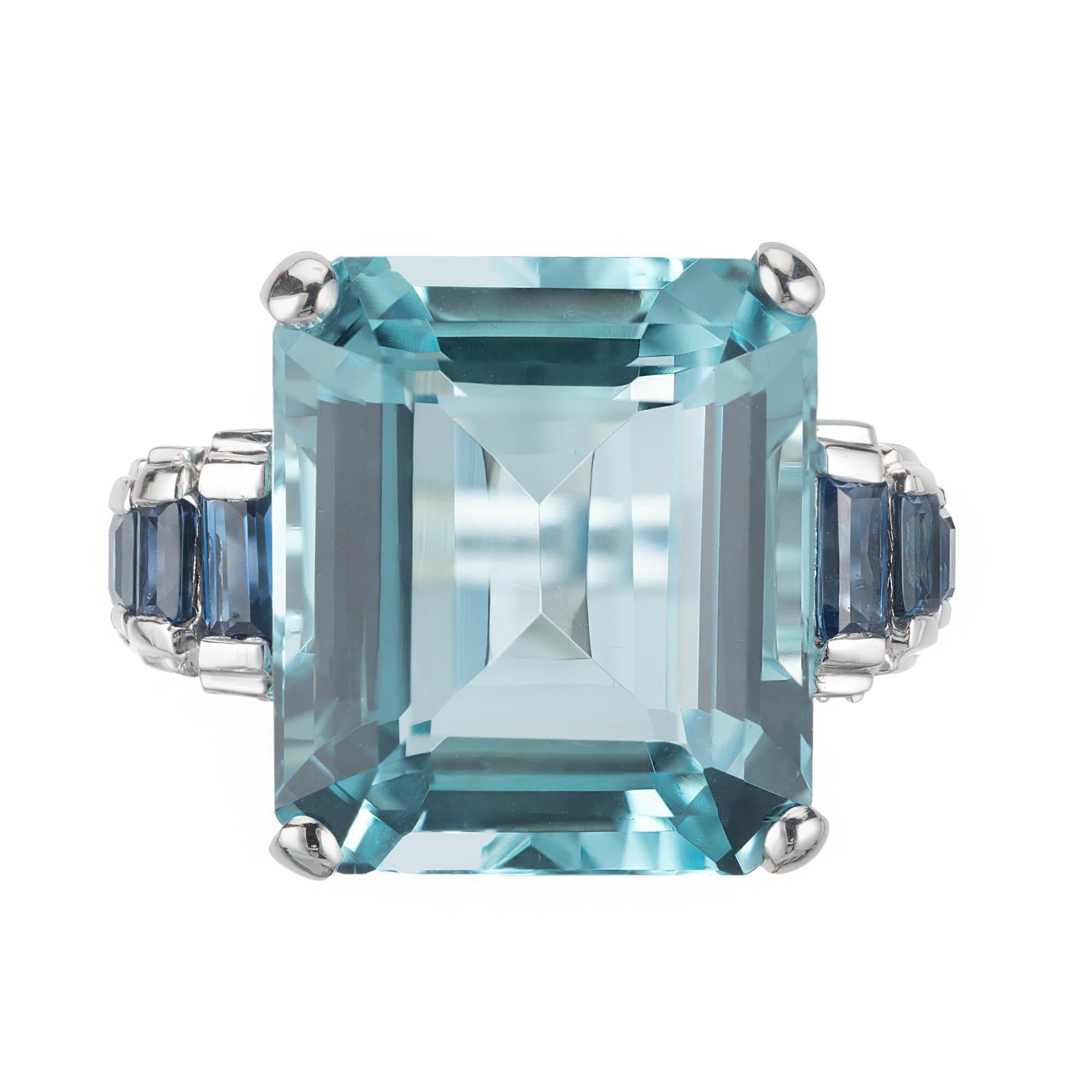 Vintage 1940s aquamarine and sapphire cocktail ring. 17.88 center aqua sits in a 18k white gold setting with six accent sapphires. 

1 square step cut blue VS aquamarine, Approximate 17.88 carats 
6 rectangular baguette blue VS sapphires,