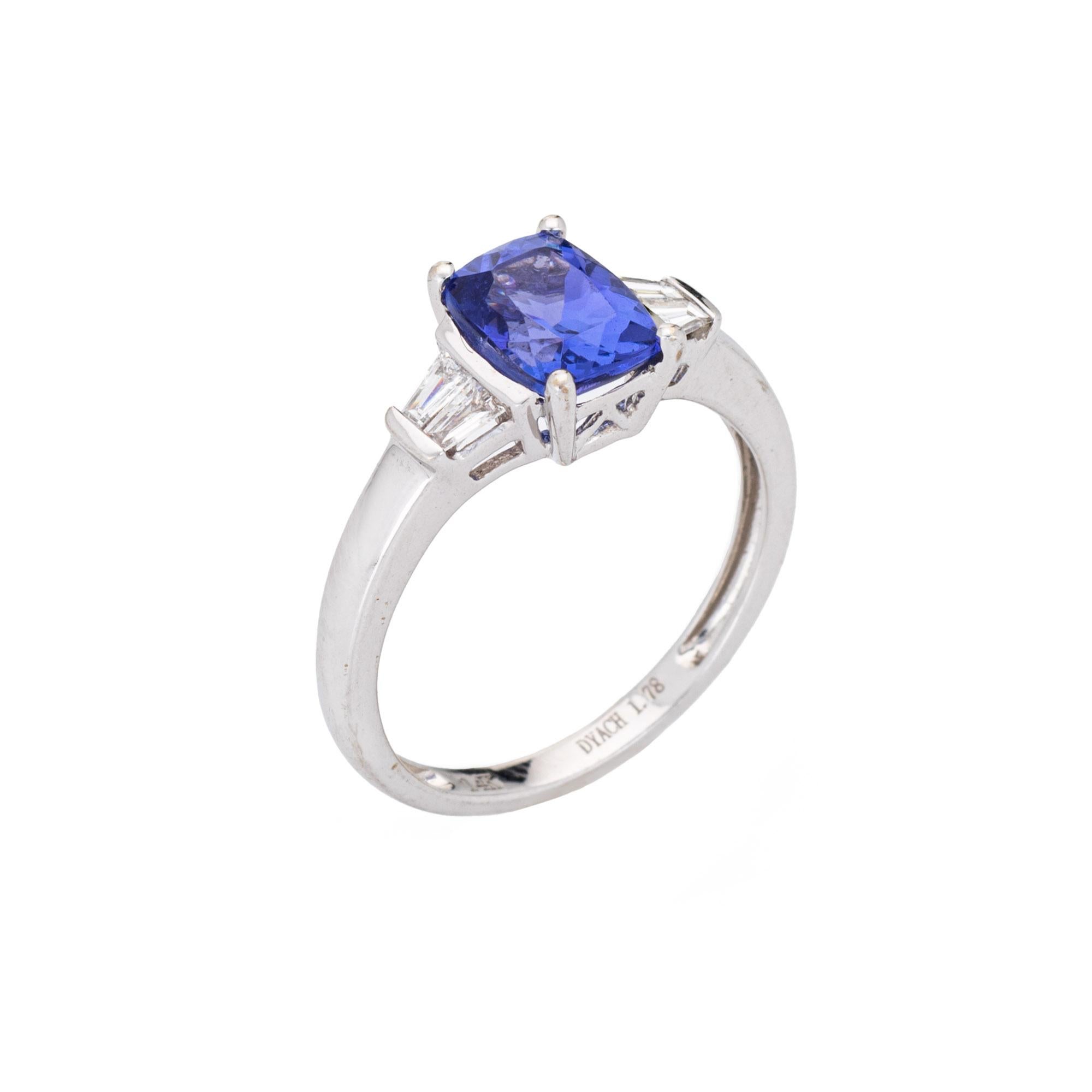 Stylish estate tanzanite & diamond ring crafted in 14 karat white gold. 

Cushion cut tanzanite measures 8mm x 6mm (1.78 carats). Four estimated 0.10 carat tapered baguette cut diamonds total an estimated 0.40 carats (estimated at G-H color and VS2