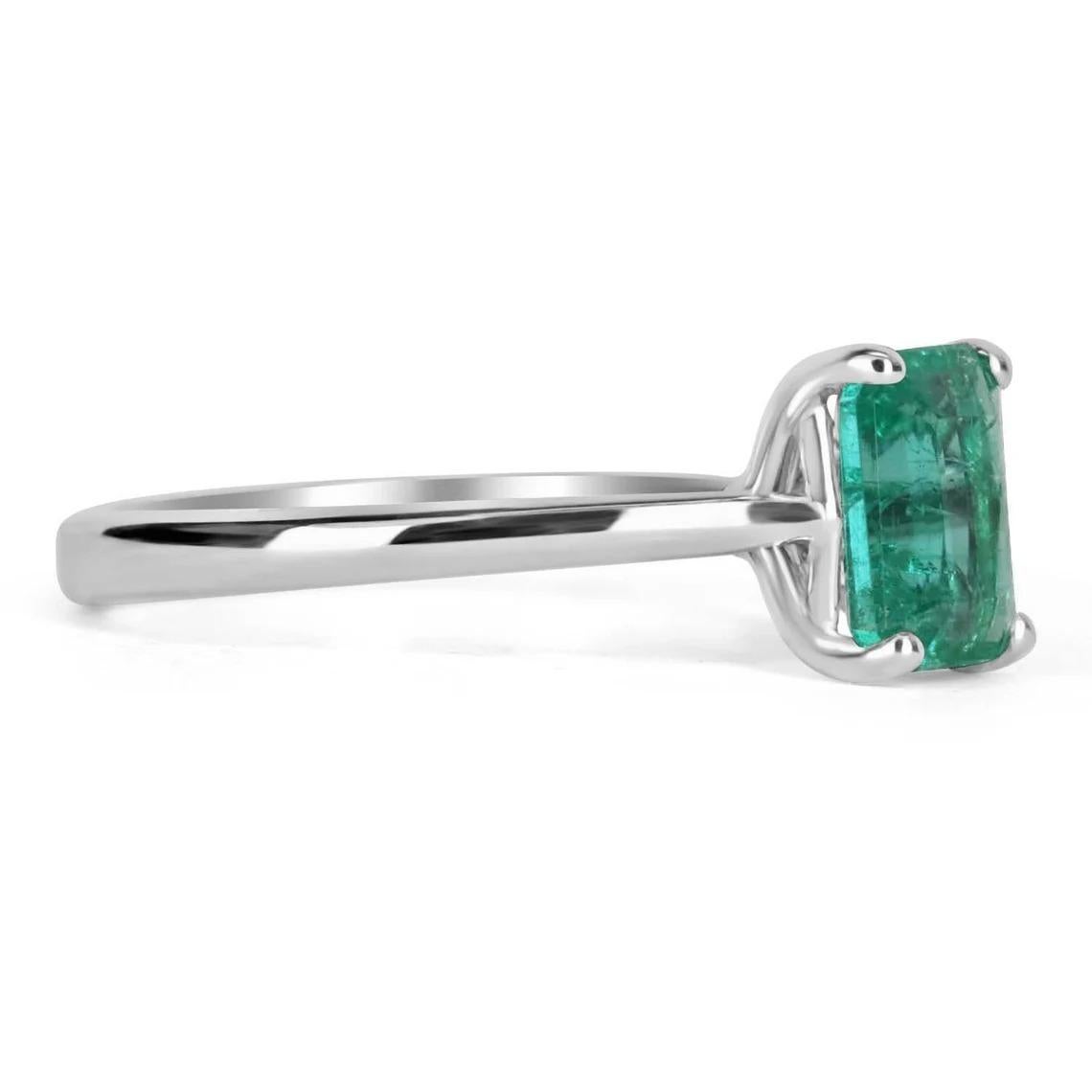Displayed is a classic solitaire engagement ring in white gold. This gorgeous solitaire ring carries a full x-carat emerald-emerald cut in a four-prong setting. Fully faceted, this gemstone showcases excellent shine. The gem has a stunning