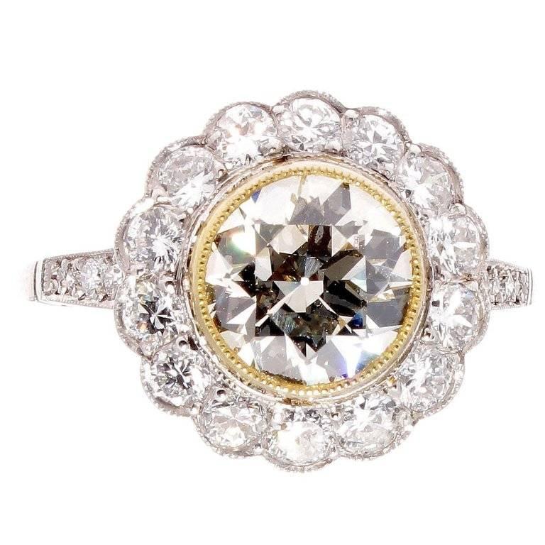 A lovely design inspired through nature's beauty which was replicated throughout the Victorian and Art Deco time periods. This vintage inspired engagement ring features a 1.79 carat old European cut diamond that is K-L color, VS1 clarity. Surrounded