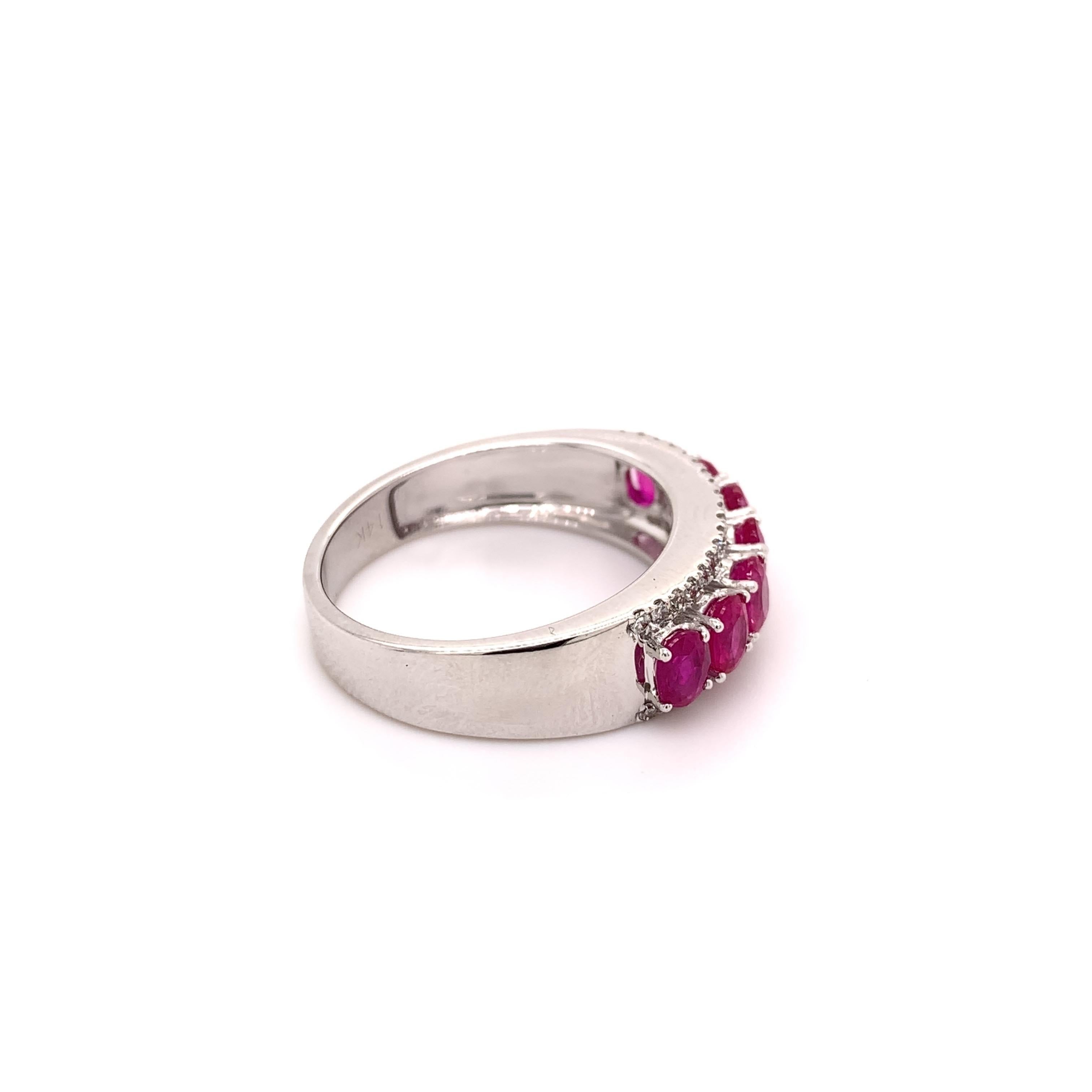 Elegant ruby diamond band ring. High brilliance, lively purplish-red oval faceted 1.79 carats natural rubies mounted in high profile open basket with bead prongs, accented with two rows of round brilliant cut diamonds.  Handcrafted design set in