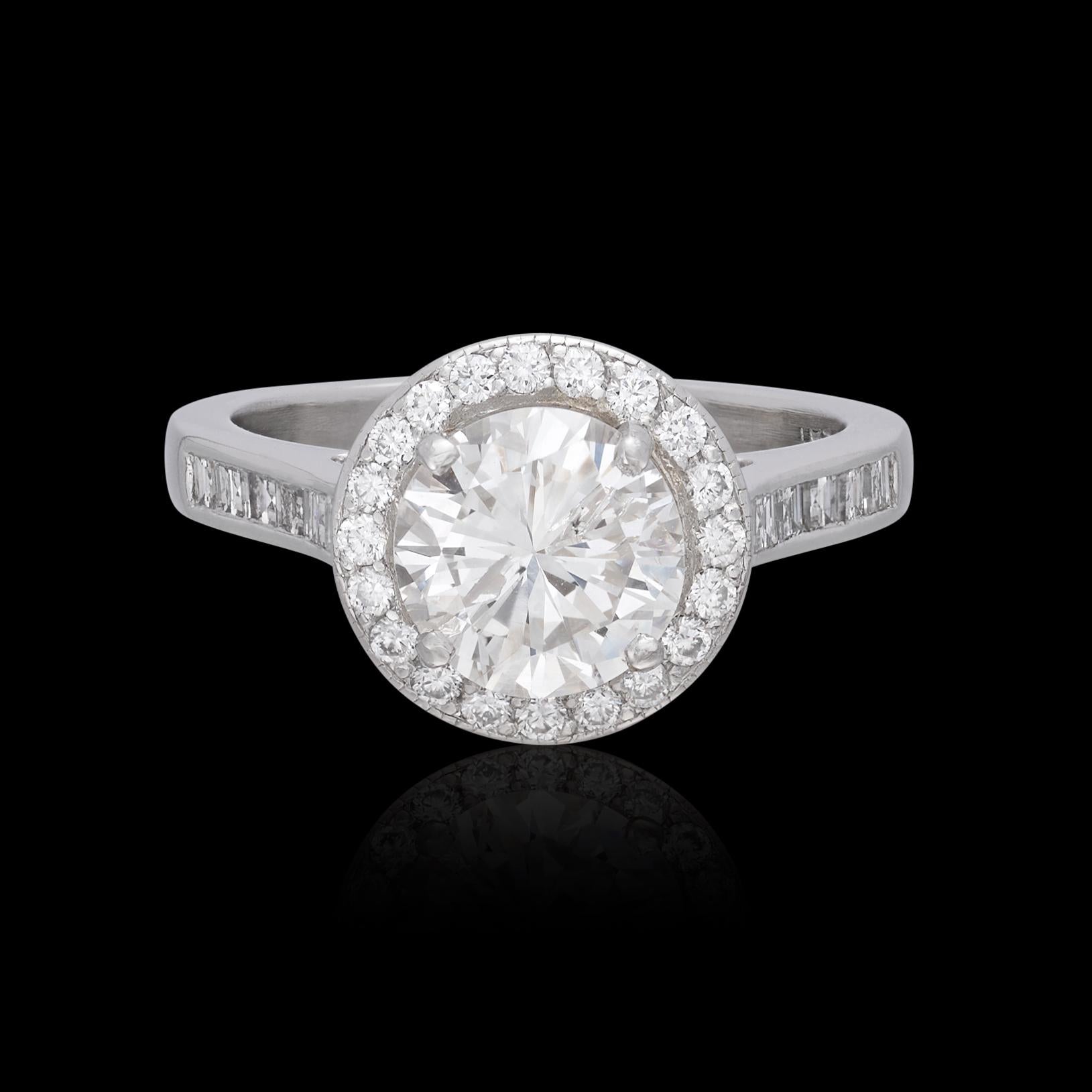 Brilliance and bold design both in this stunner of a ring. Featuring a prong-set round brilliant-cut diamond weighing 1.79 carats (+/-K/I1), accented with a halo of round brilliant-cut diamonds, square-cut diamond shoulders, and two accent stones,