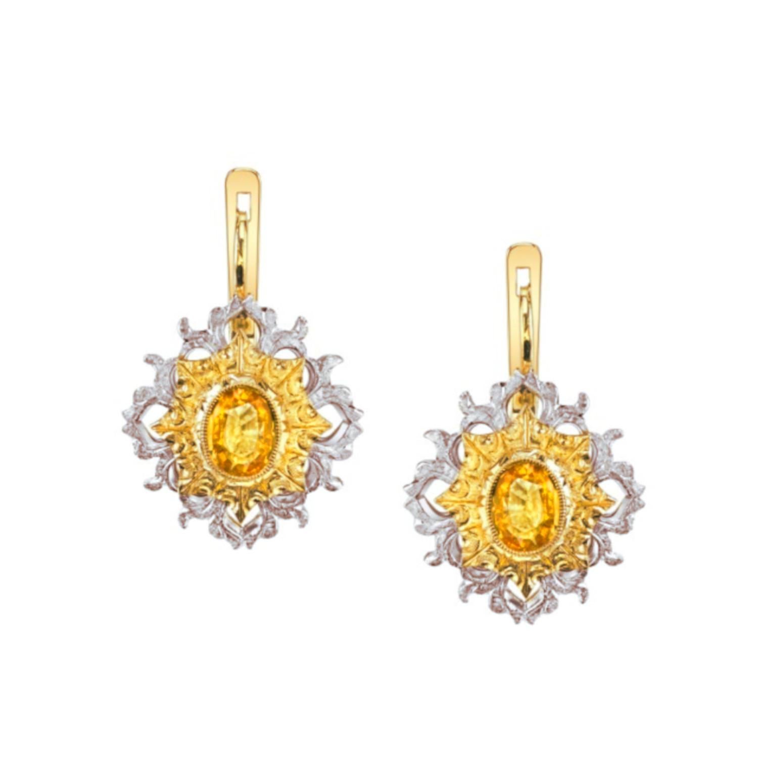 These spectacular yellow sapphire drop earrings were hand crafted in 18k white and yellow gold by our Master Jewelers in Los Angeles and feature a beautifully matched pair of deep lemon-yellow color sapphires! The bezel set sapphires are  framed