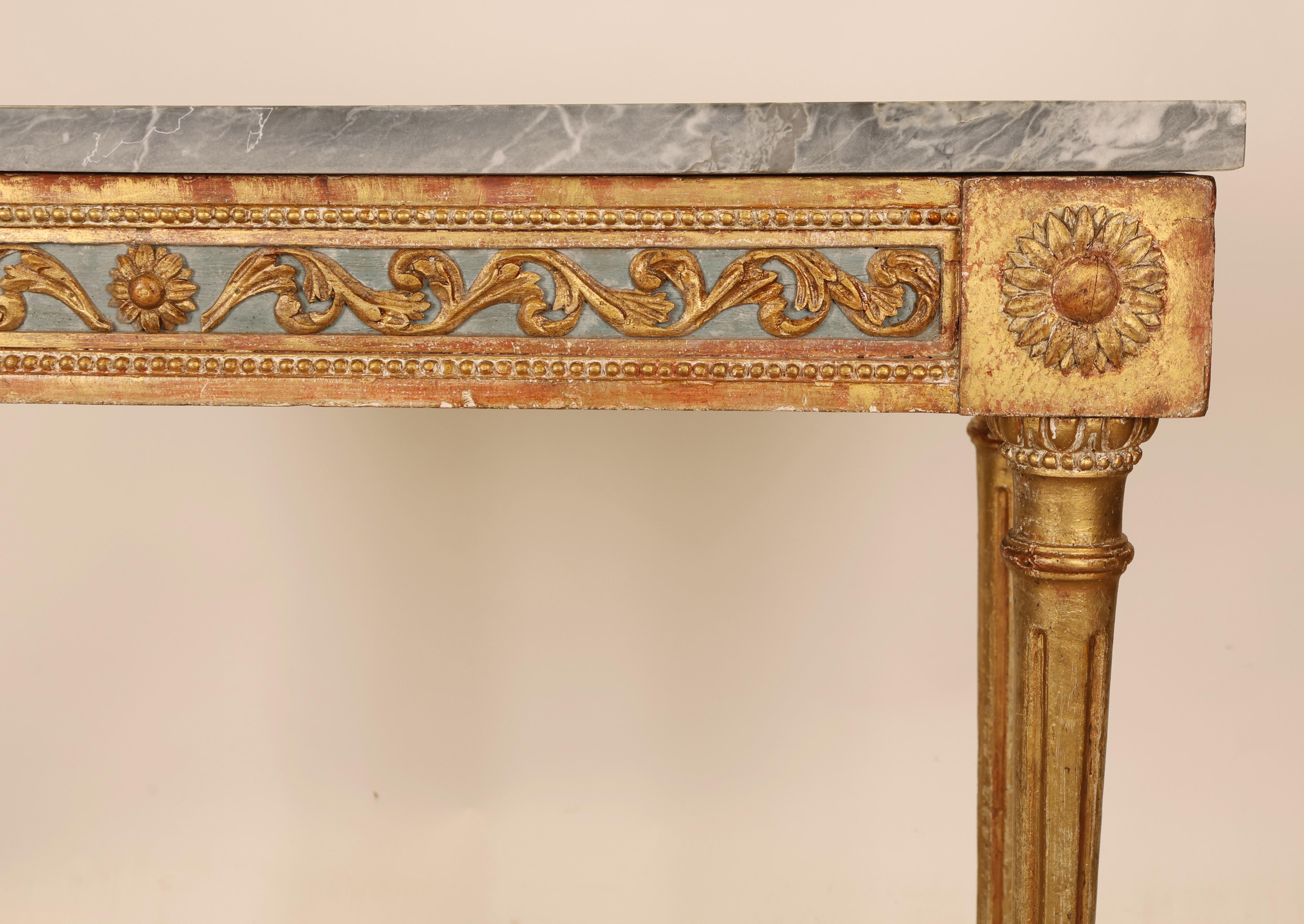 A late Gustavian Stockholm piece from the 1790s, featuring carved wooden decoration along the apron in the form of acanthus leaves. The corners of the table are adorned with carved, stylized sunflowers. The tabletop is made of bleu turquin marble.
