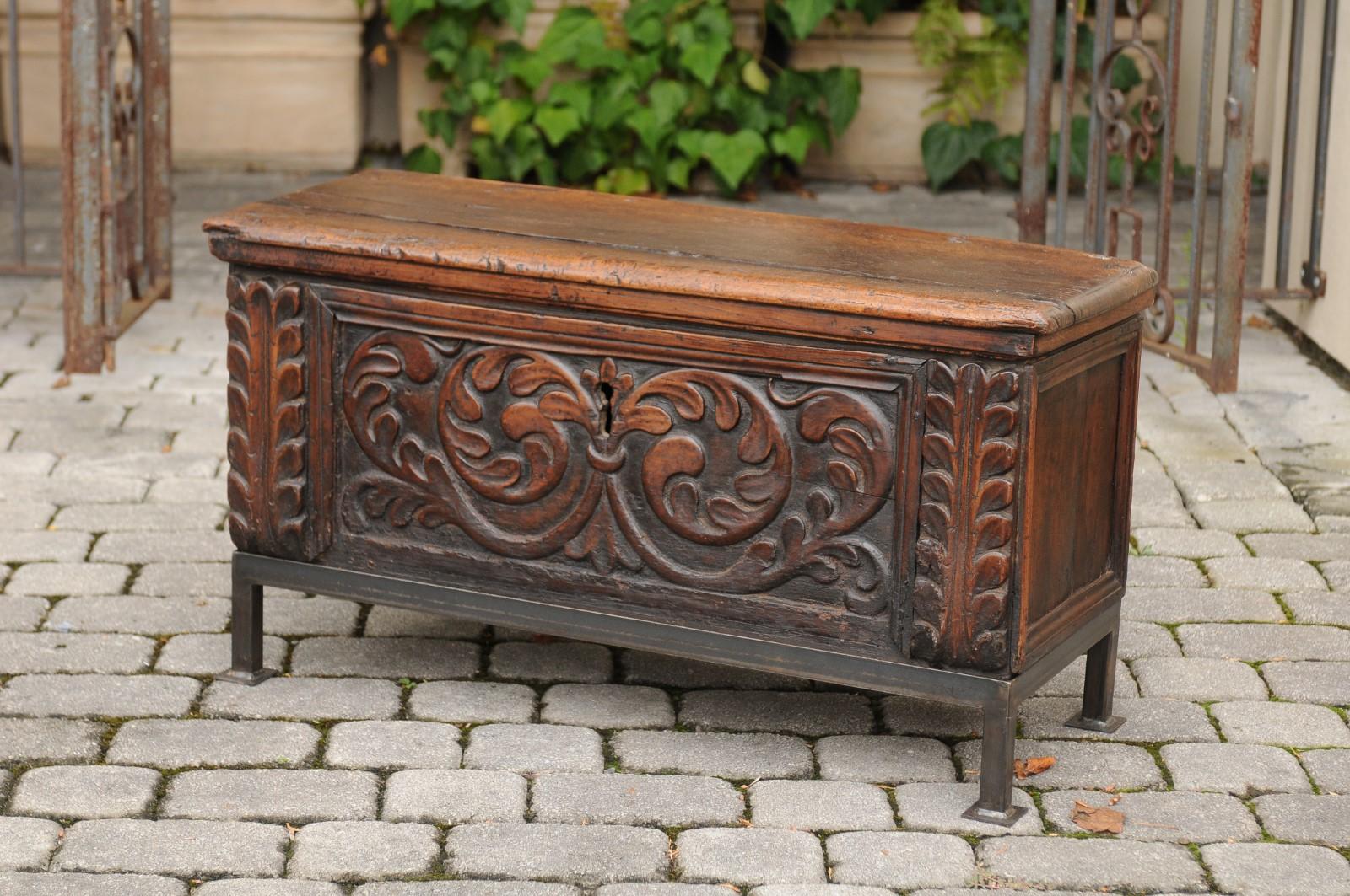 An English George III period hand carved walnut coffer from the late 18th century mounted on a new custom made base. Born in the later years of the 18th century, this exquisite coffer features a rectangular lid with rounded edges, opening to reveal