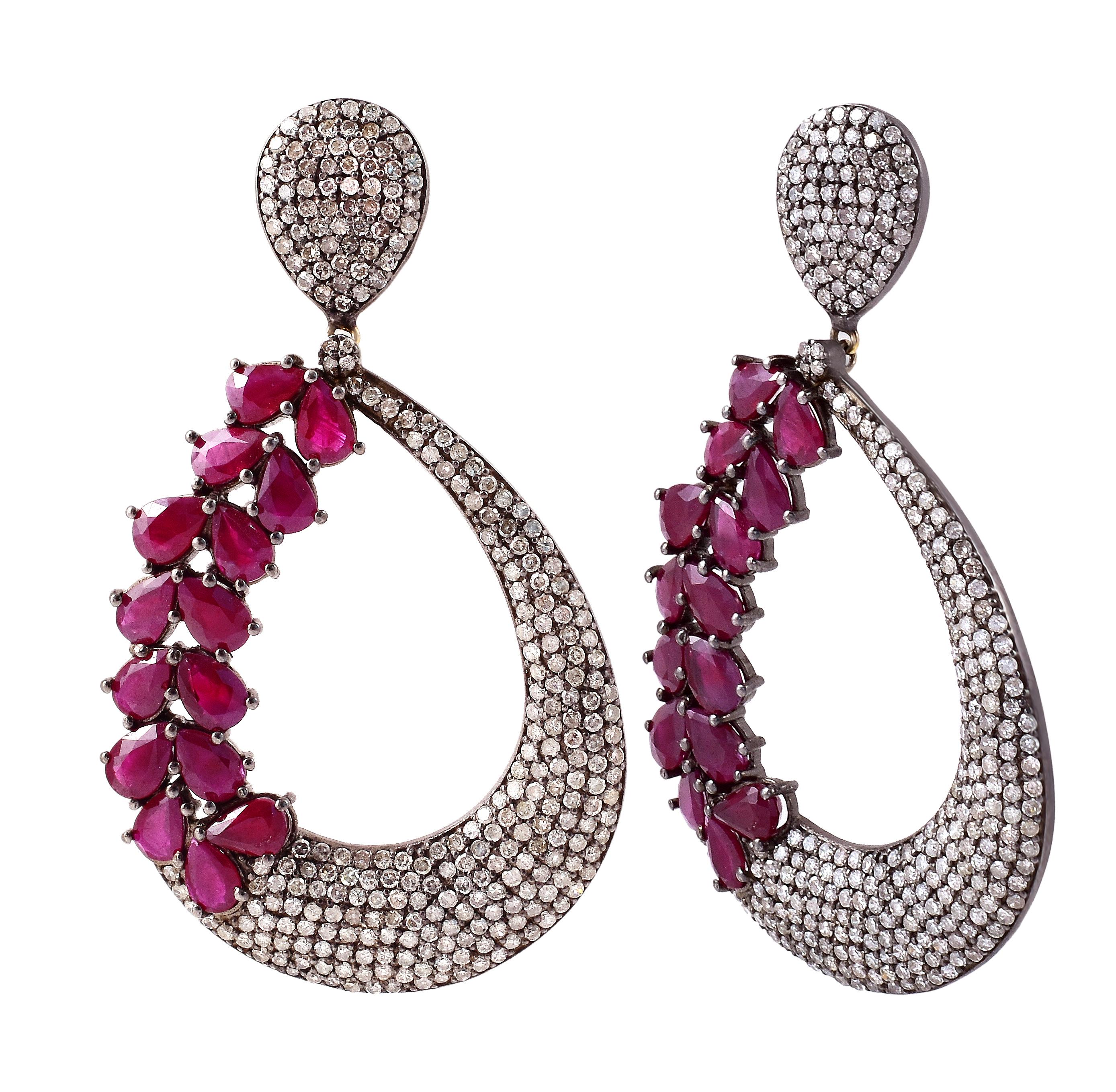 17.91 Carat Ruby and Diamond Dangle Cocktail Earrings in Victorian Style

This Victorian-style majestic crimson red ruby and diamond earring is exquisite. The open broad pear-shaped long earring pair is hollow in the center. It starts with several