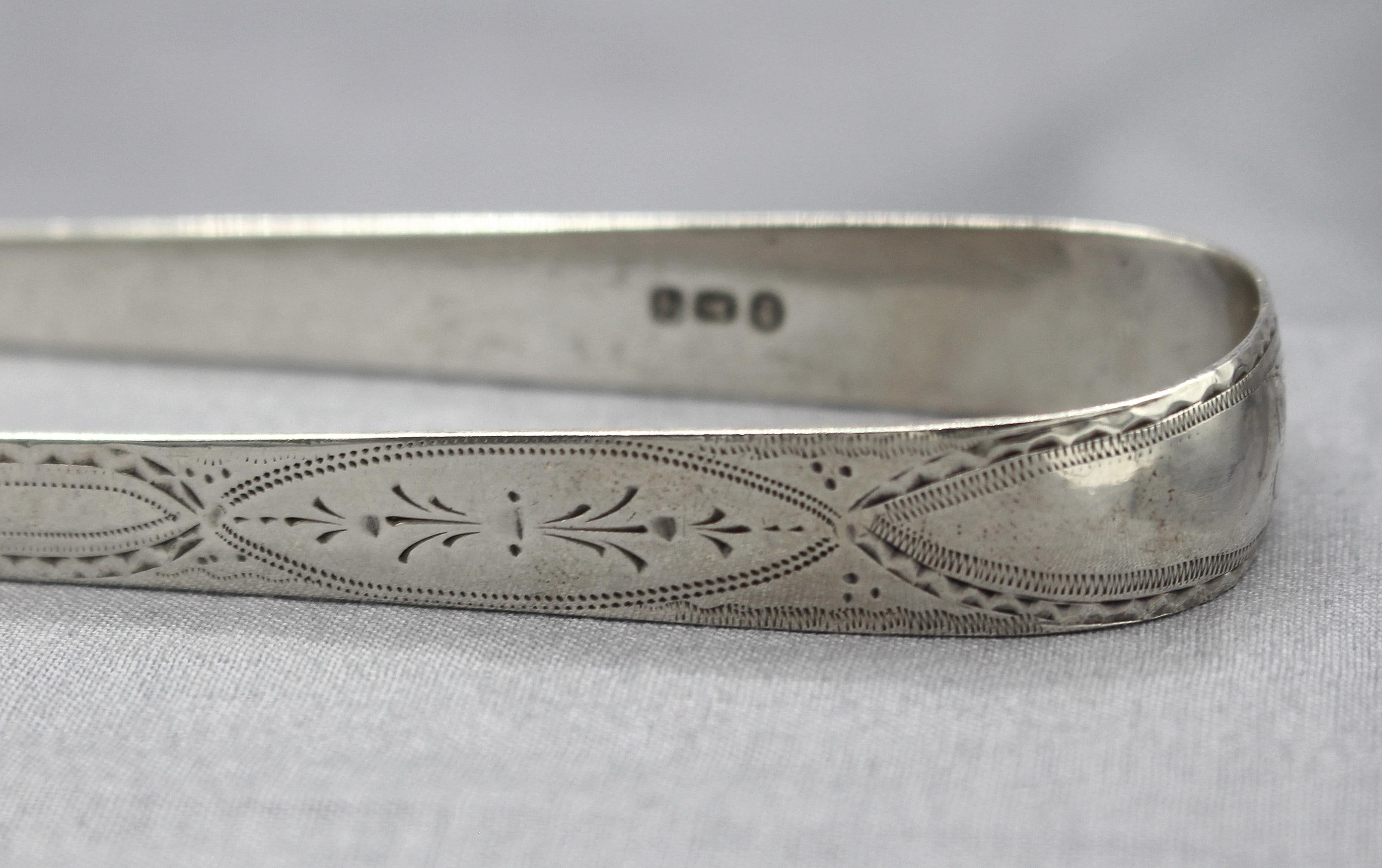 1791 sterling silver sugar tongs by Peter & Jonathan Bateman, England. Peter & Jonathan's partnership lasted only 6 months due to Jonathan's premature demise in 1791. Bright cut work. Marks overstruck by another silversmith/retailer. Engraving