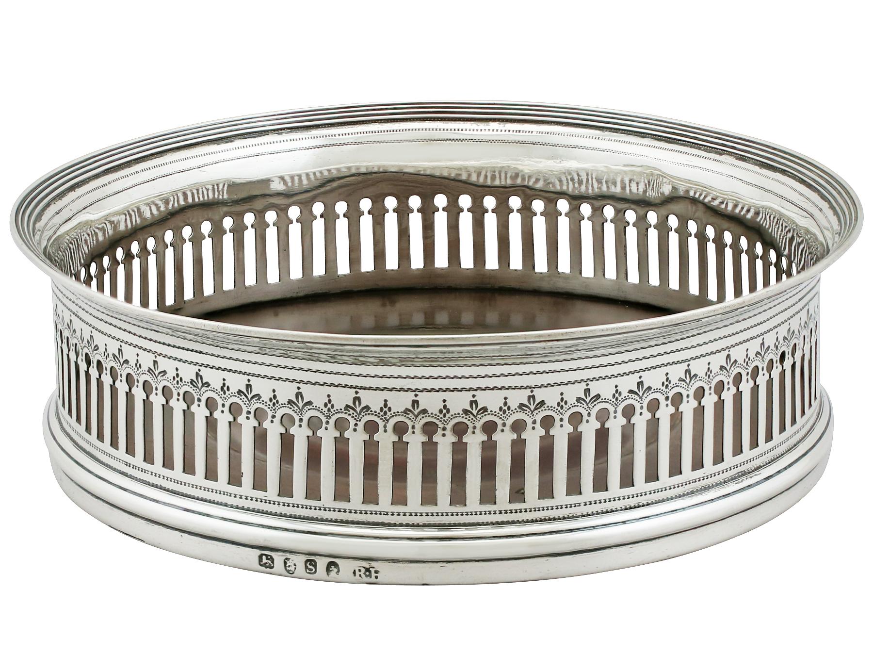 An exceptional, fine and impressive antique George III English sterling silver coaster; an addition to our Georgian silverware collection.

This exceptional antique George III sterling silver wine coaster has a cylindrical form with a rounded