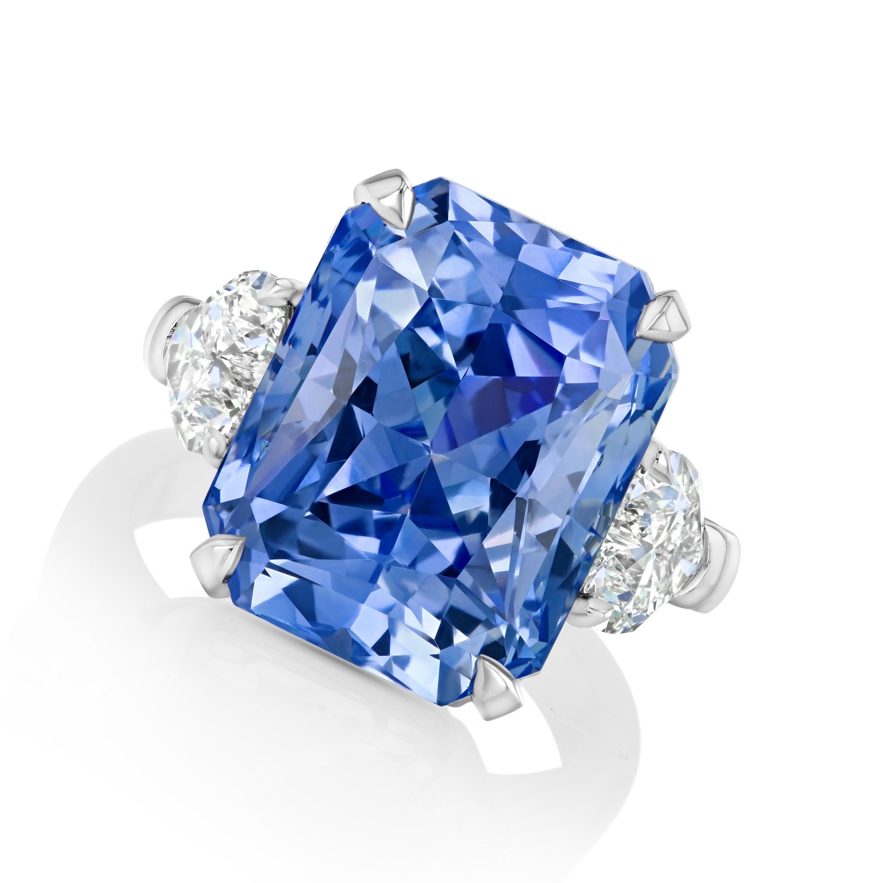 17.93-carat, Blue Sapphire from Sri Lanka is flanked by two heart-shaped Diamonds weighing 1.42 carats, fabricated in platinum. GIA Certified. 