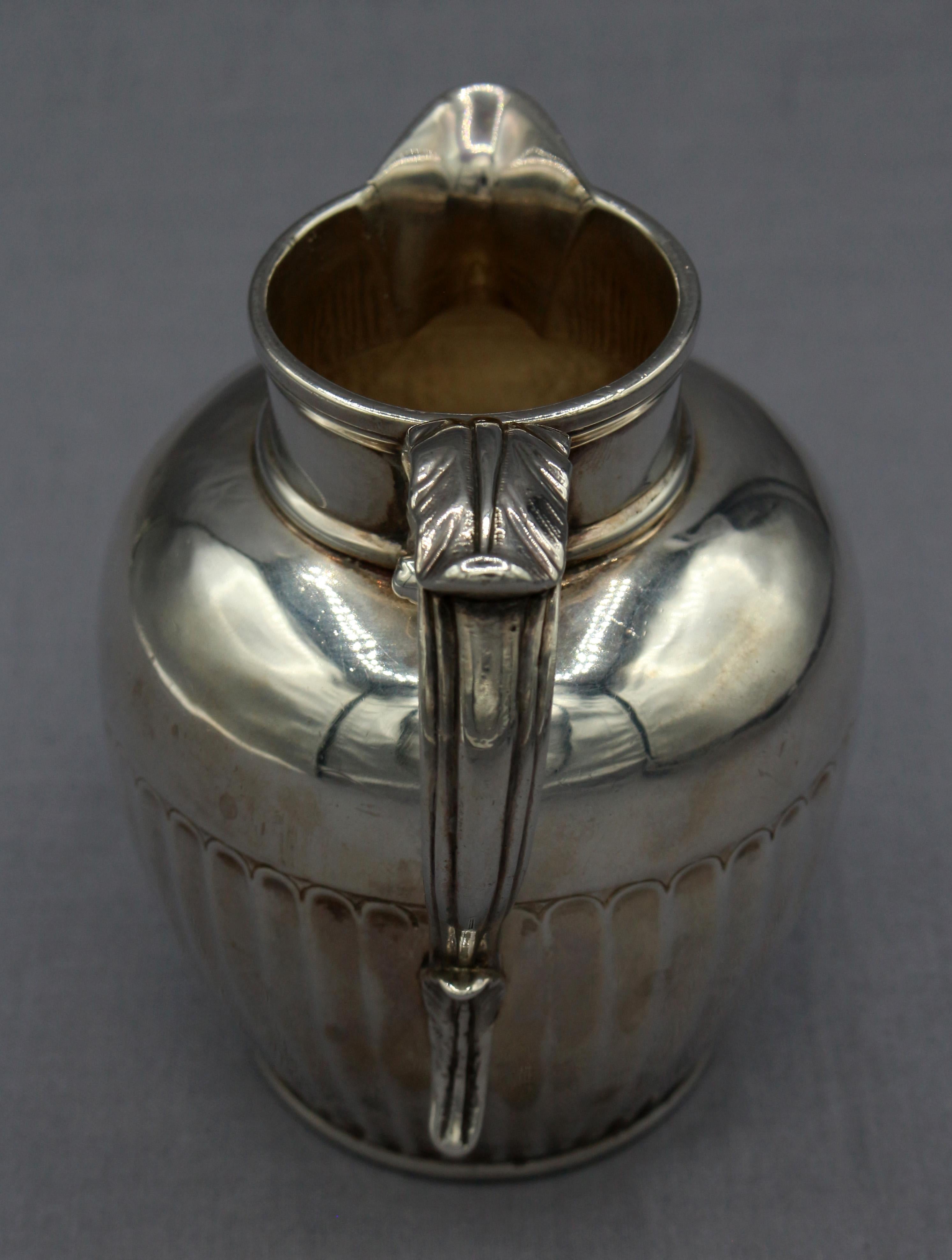 Sterling silver cream jug by Hester Bateman, 1793, London. Handsome with fluted body & acanthus leaf scrolled handle. Here we see the family mark (Hester & Son) for date used on their classic jug form (it appears as late as 1812). Cursive script HB