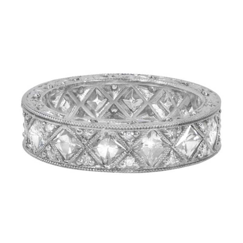 A breathtaking platinum band adorned with fourteen stunning French-cut diamonds. Each diamond is meticulously set in fine milgrain bezels, complemented by pave set diamonds on both sides. The band features an additional row of milgrain on each side,