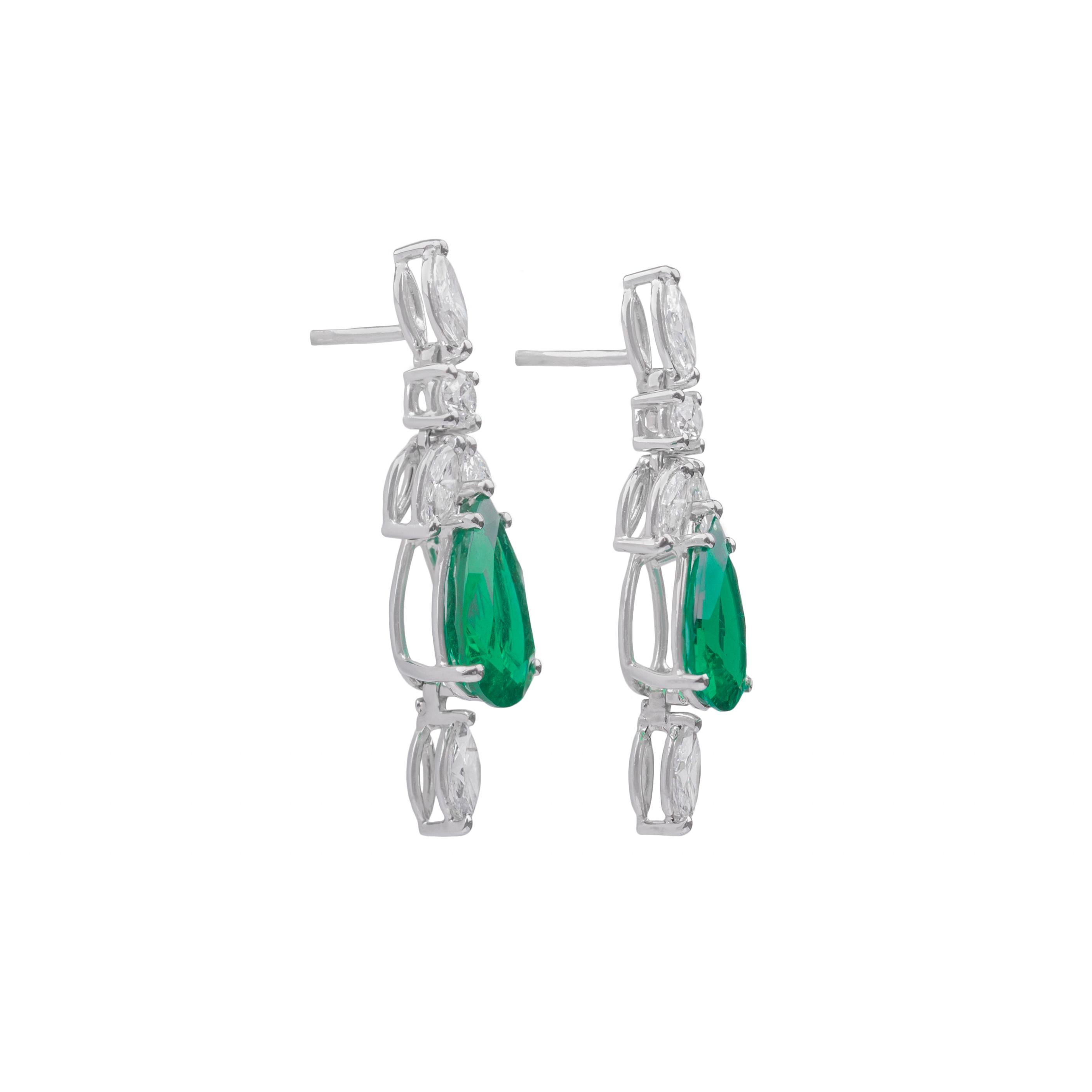 These diamond and pear cut emerald earrings, finely crafted in 18k white gold are made in Italy by Fanuele dal 1905. The two pear cut emeralds are finely combined with navette (marquise) and brilliant cut diamonds.
These dangly earrings feature a