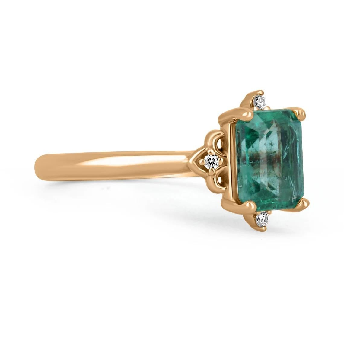 Displayed is a contemporary emerald and diamond engagement ring/right-hand ring in 14K rose gold. This gorgeous ring carries a full 1.74-carat emerald in a secure four-prong setting. Fully faceted, this gemstone showcases excellent shine and