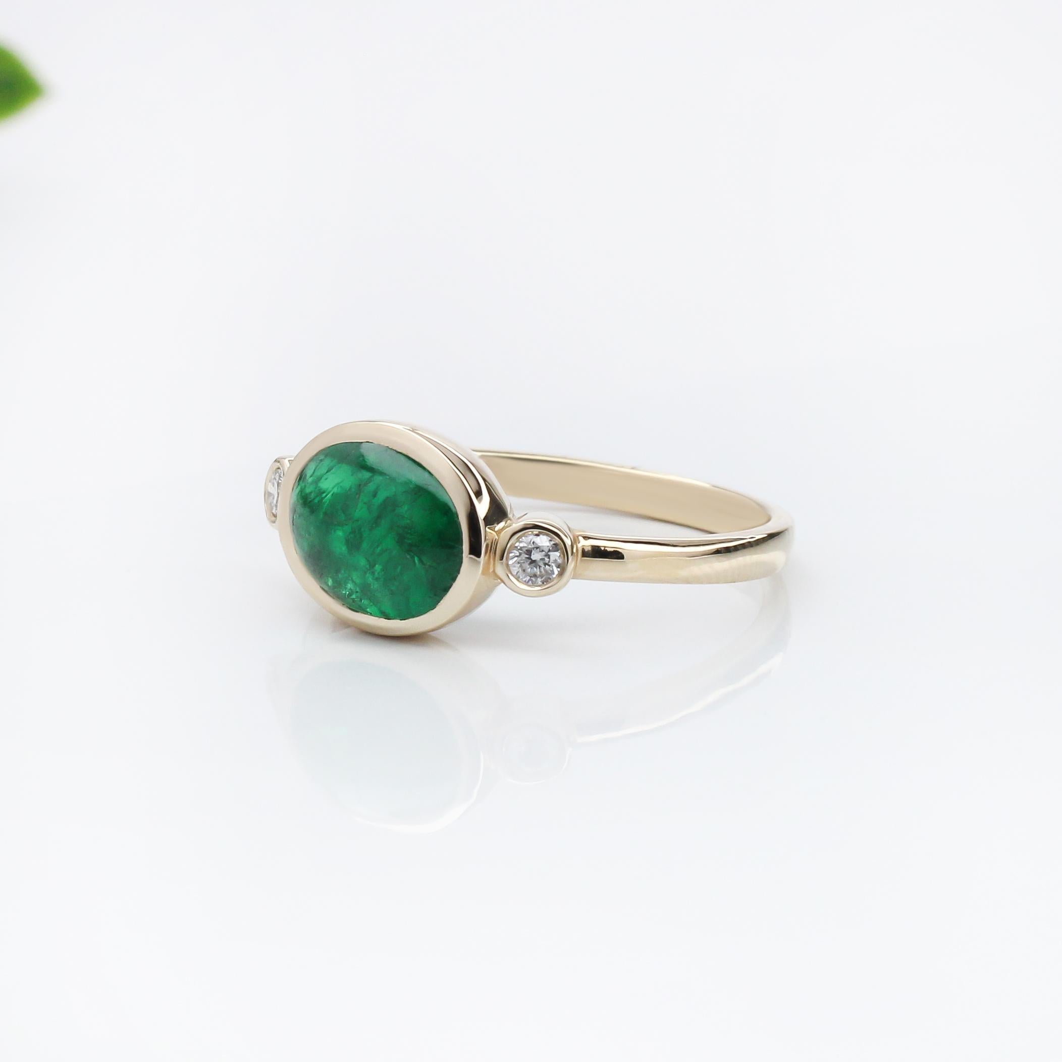 This elegant ring features a captivating 1.72 carat oval-shaped east west emerald, set in a polished band. Flanking the central stone are two round natural earth mined diamonds, adding a touch of sparkle. The emerald's rich green color is