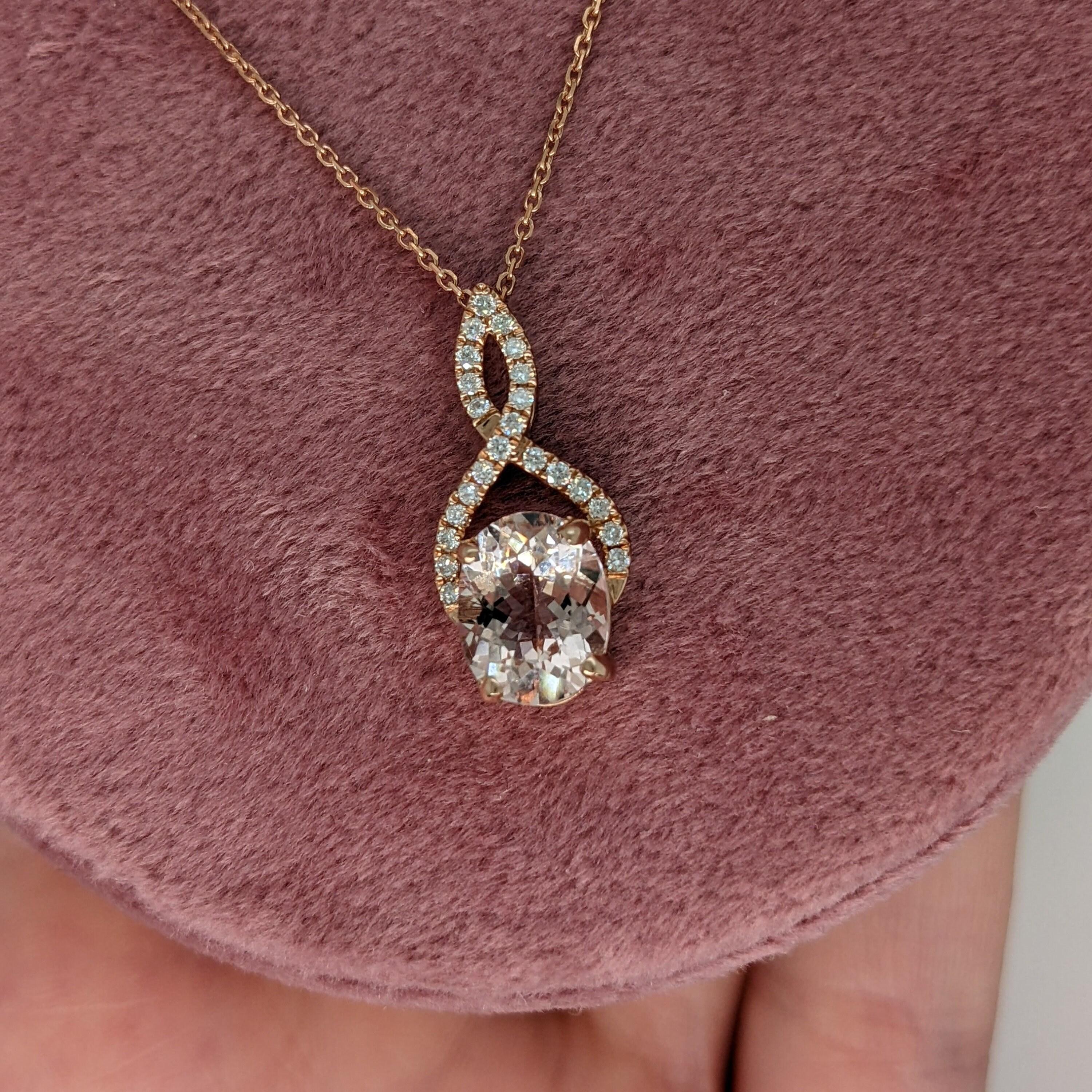 A beautiful Morganite Pendant with an infinity loop inspired design and sparkling natural diamond accents. 14k rose gold makes this piece extra unique and extra pink! The prong setting shows off this beautiful oval morganite while holding it