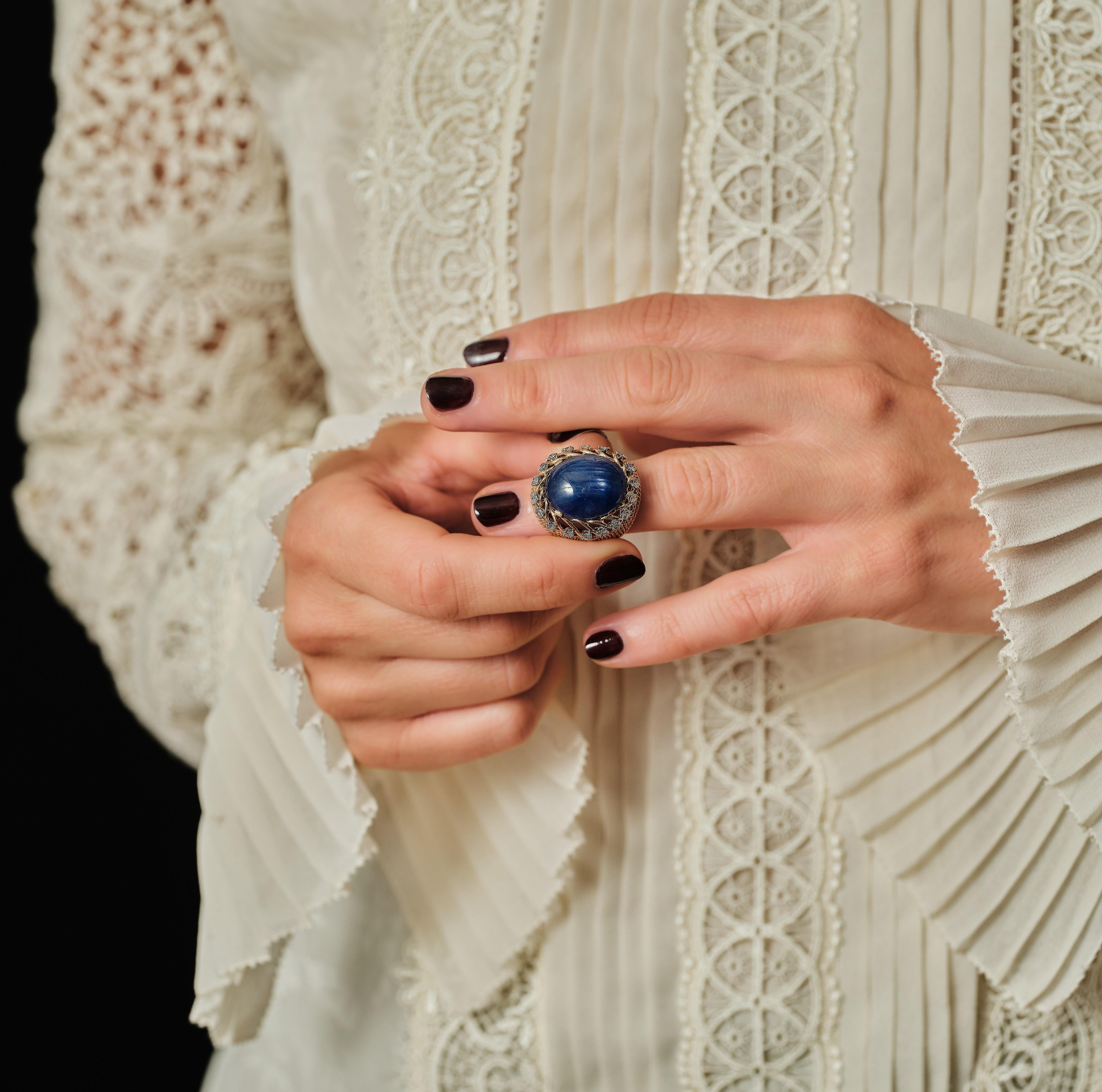 Elegant 1960s star sapphire ring band by Pierre Sterlé, Paris.

Ring made in 18 karat gold, 750, with platinum, 850, details, the braided setting adorned with a cabochon of shimmering claw-set sapphire surrounded by 18 brilliant-cut diamonds.