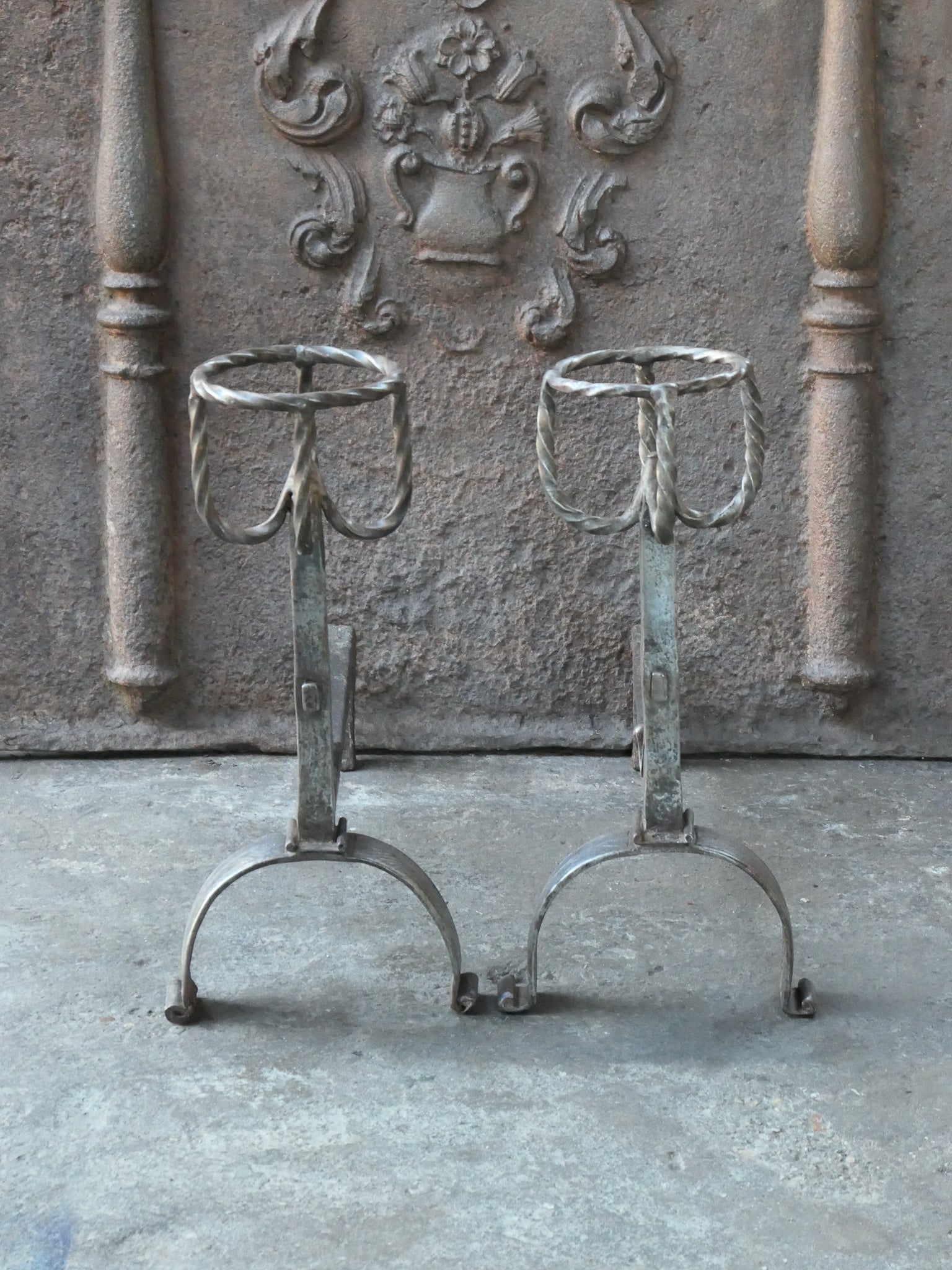 17th/18th Century English andirons made of polished steel. The andirons have a Gothic period style. The condition is good.