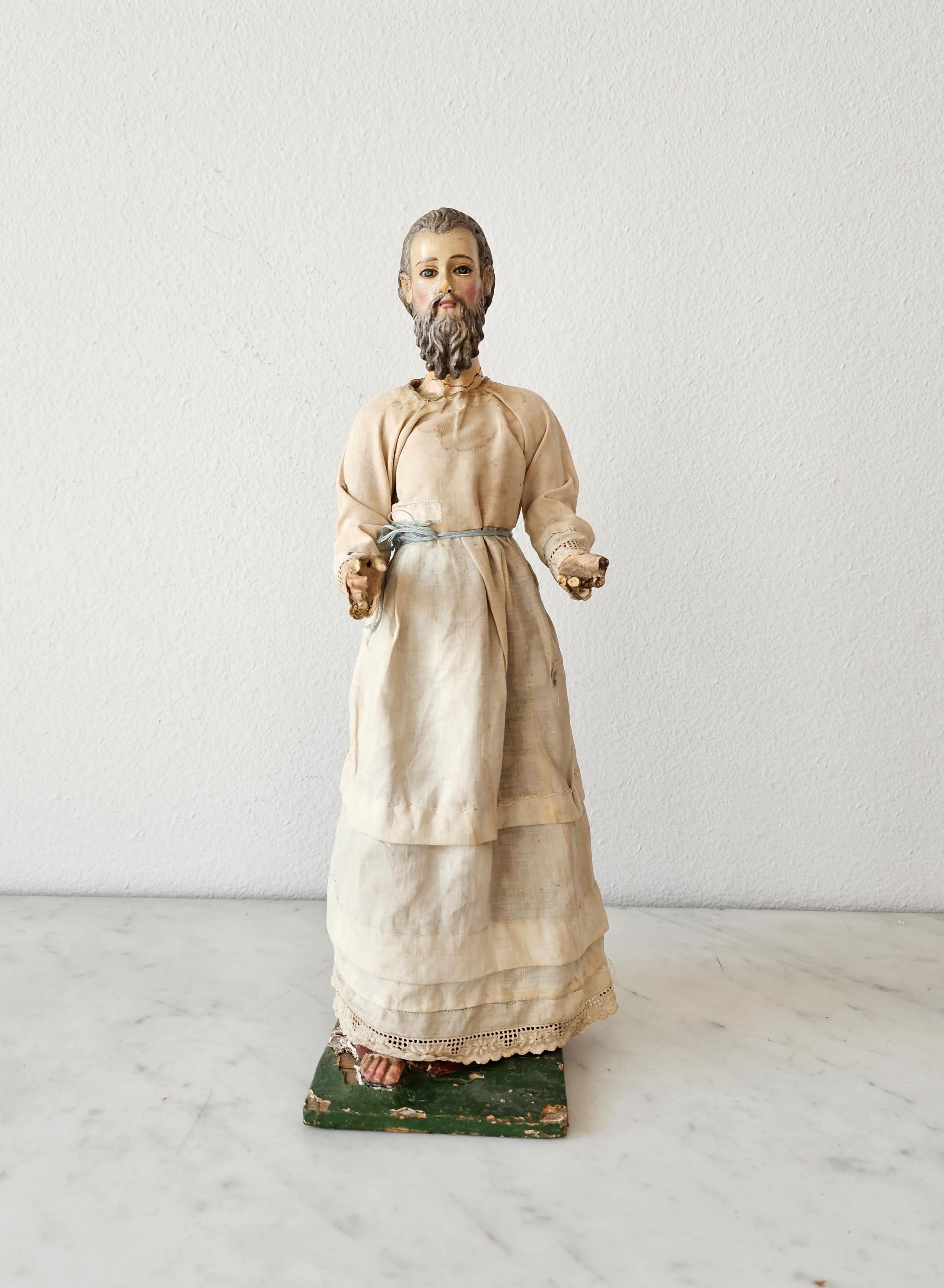 A scarce Baroque period Spanish or Italian hand carved polychrome painted wood Santo sculpture with inset colored glass eyes, original white robe garb and later wood rosary.

Intricate and highly realistic detailing, the exceptionally executed late