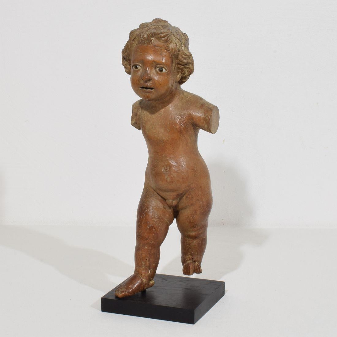 Beautiful baroque baby Jesus with glass eyes and a very strong expression. Wonderful and rare original period piece. Spain, circa 1650-1750.
Weathered, losses and old repairs.
Measurements include the wooden base.