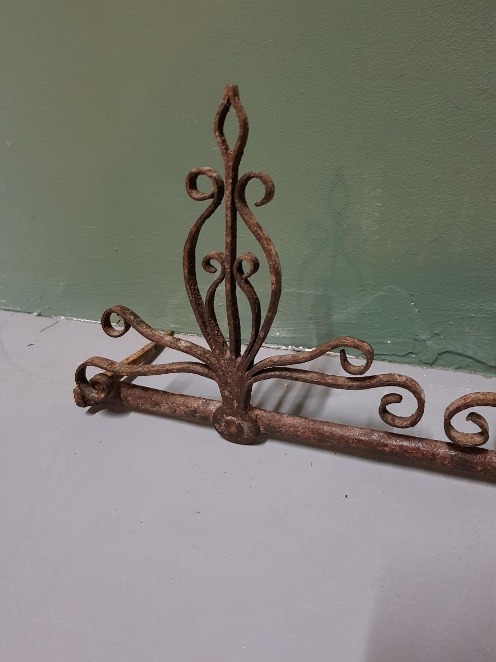 17th-18th century Dutch wrought iron wall rack for fireplace tools, in a good condition and with a beautiful patina.

The measurements are:
Depth 10.5 cm/ 4.1 inch.
Width 35.5 cm/ 13.9 inch.
Height 17 cm/ 6.6 inch.