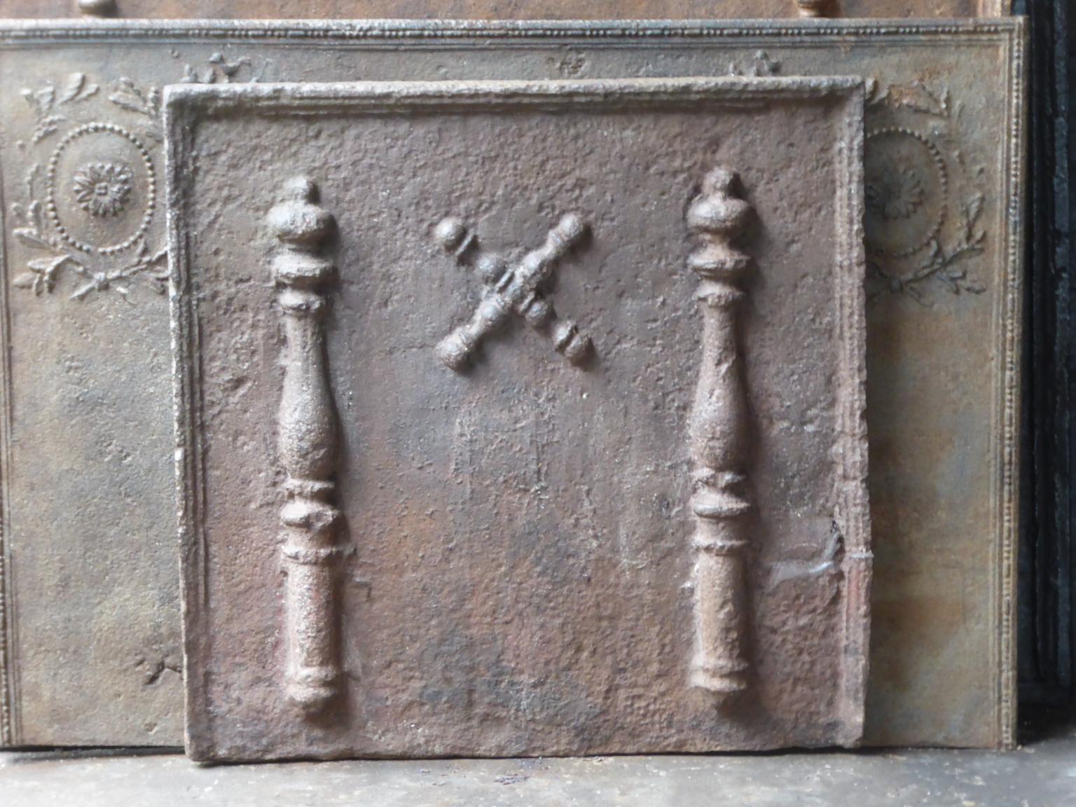 Beautiful 17th-18th century French fireback with a Saint Andrew's cross and two pillars of Hercules. Saint Andrew is said to have been martyred on a cross in this shape. The cross is since then a sign for humility and sacrifice. The pillars of