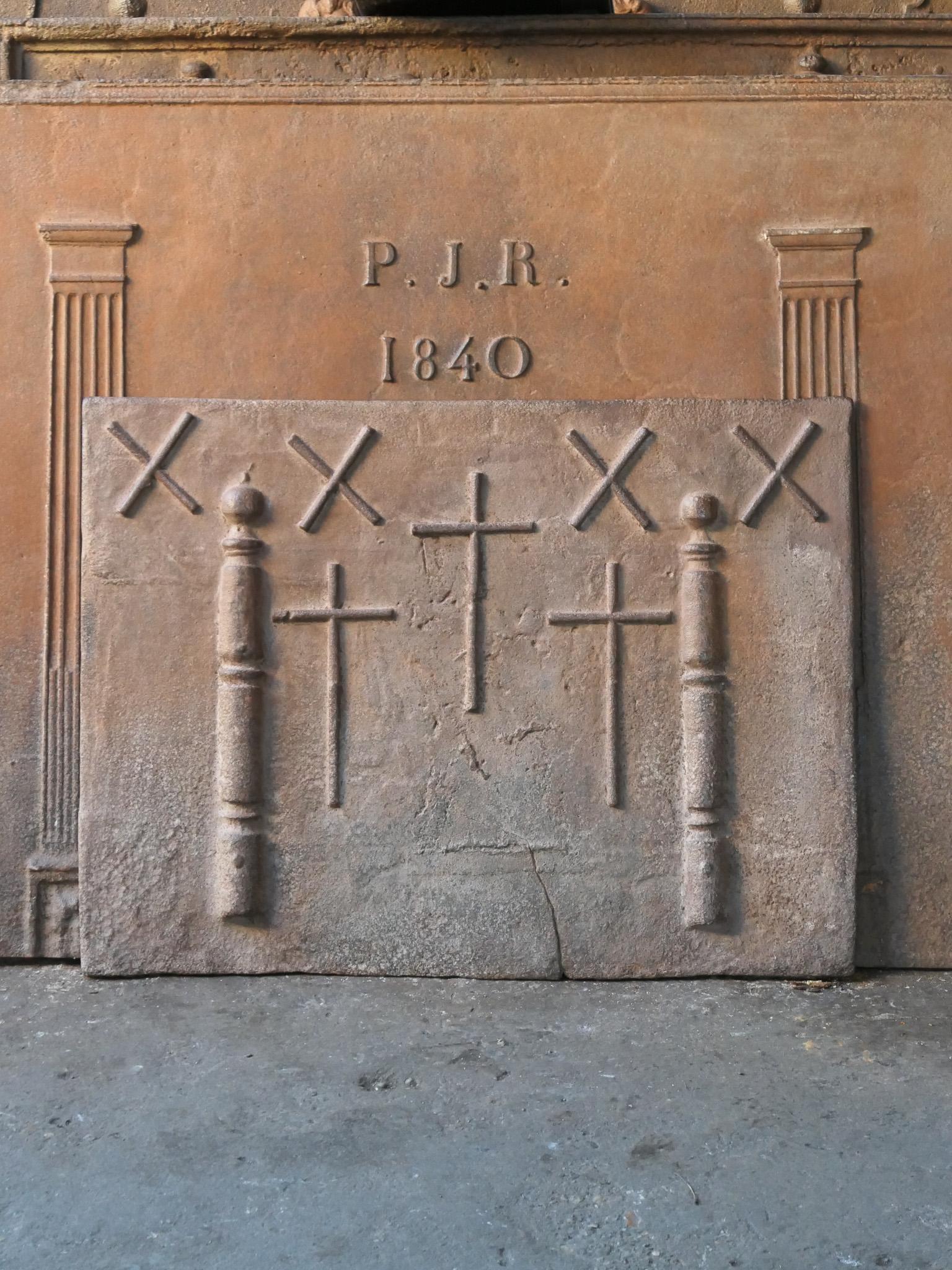 17th-18th century French fireback with four Saint Andrew's crosses and two pillars of Hercules. Saint Andrew is said to have been martyred on a cross in this shape. The cross is since then a sign for humility and sacrifice. The pillars of Hercules