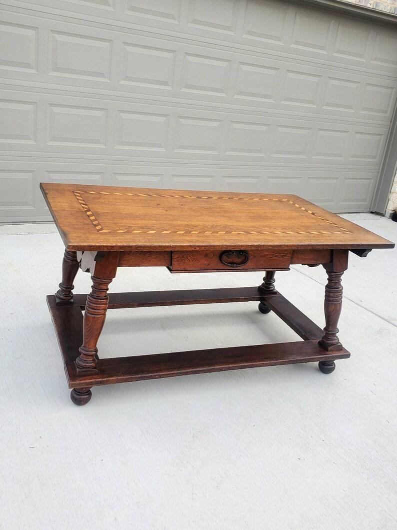 An early European oak pay table with beautiful, rich, rustic, elegantly aged patina. 

Born in Switzerland in the 18th century, likely in the Swiss Alps near the French border, hand-crafted of high-quality solid oak, the Baroque period table is in
