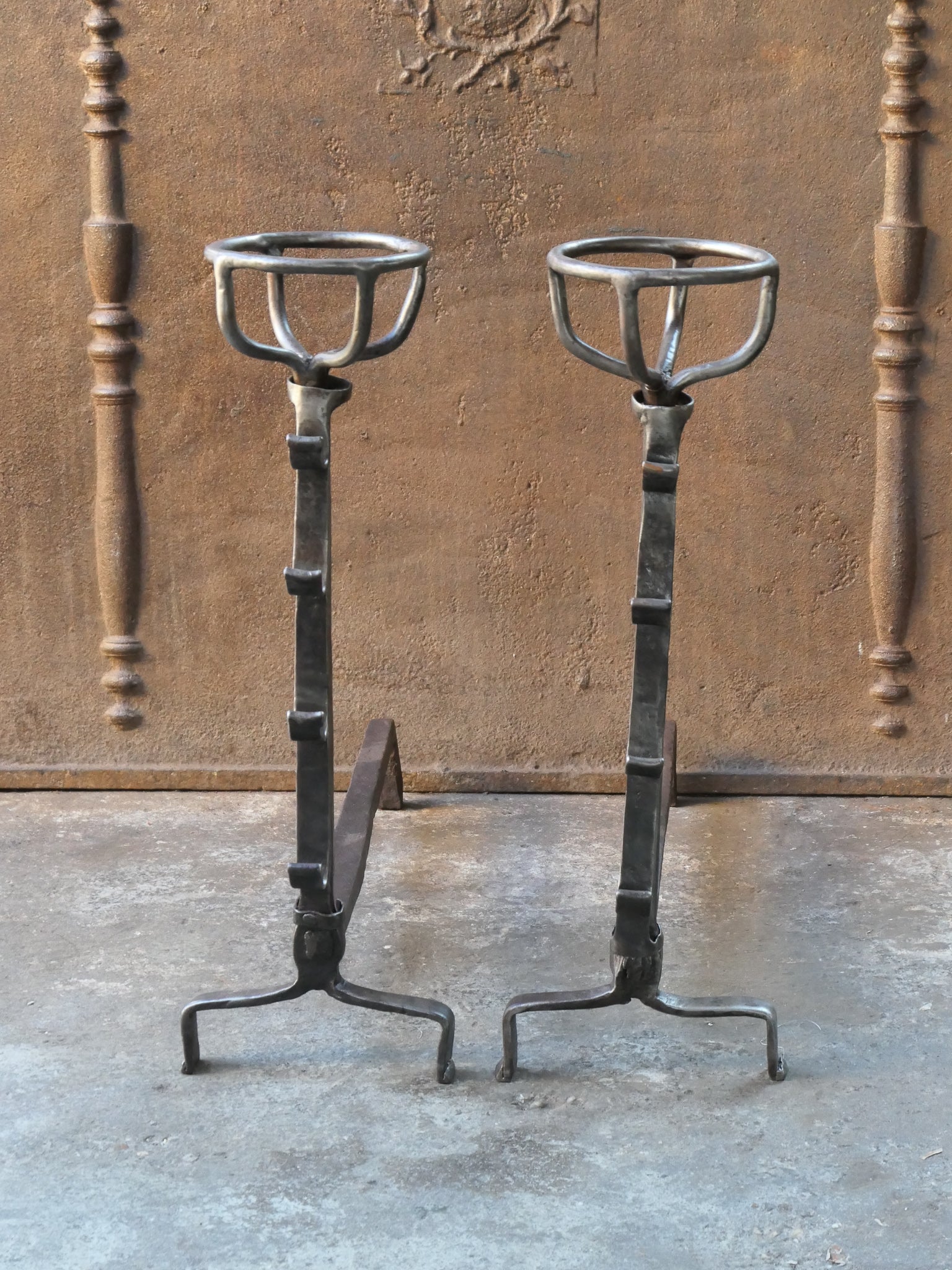 17th - 18th century French andirons - fire dogs made of wrought iron. These French andirons are called 'landiers' in France. This dates from the times the andirons were the main cooking equipment in the house. They had spit hooks to grill meat or