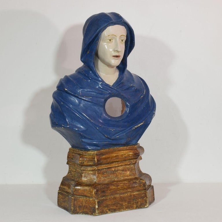 Spectacular and very decorative piece. Large carved wooden reliquary bust of a Madonna. Beautiful colors. Small losses and without the relics. Italy circa 1650-1750. Weathered, small losses and to my opinion paint once restored.
More photo's