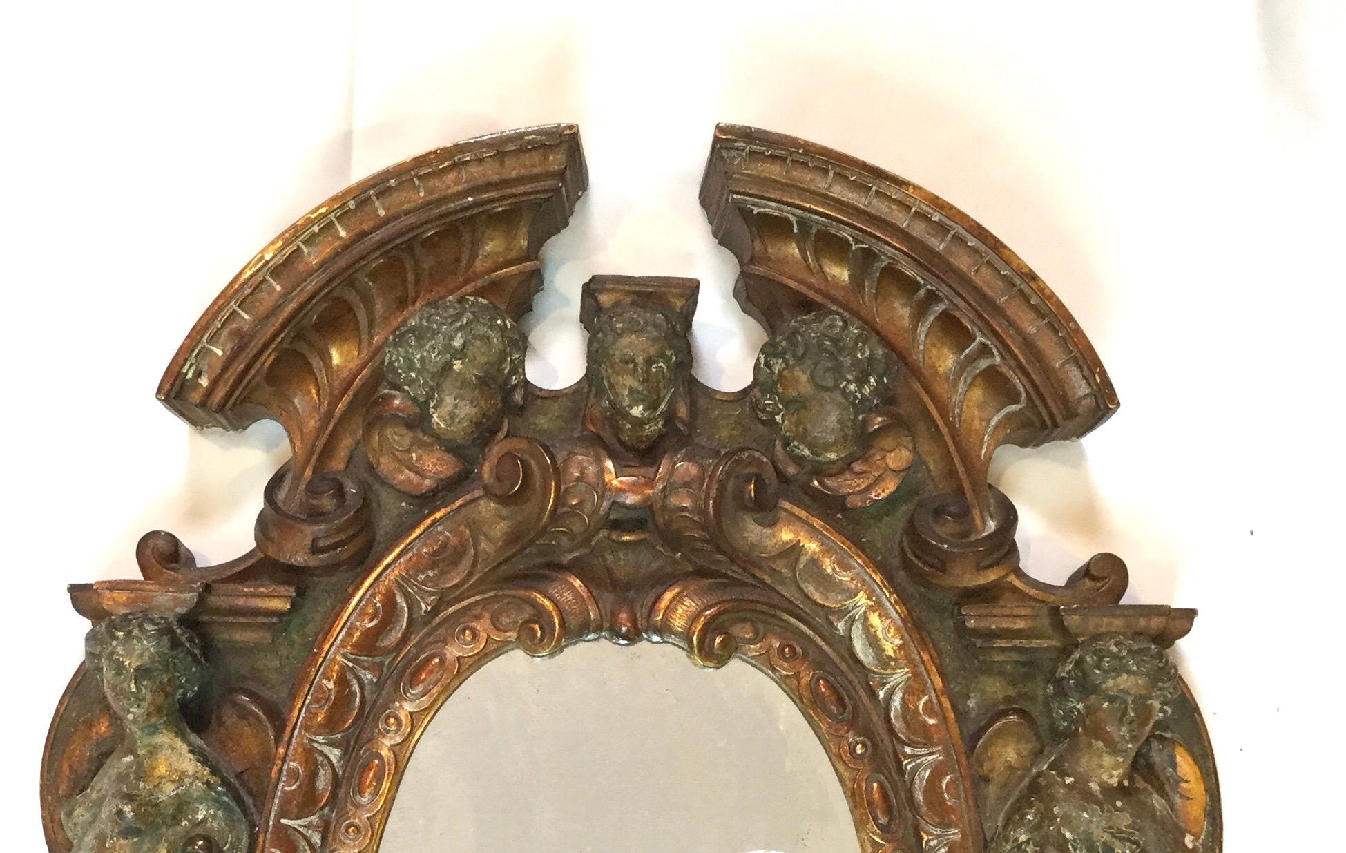 17th-18th century mixed metal Italian Renaissance mirror, made in Tuscan Italy
Exceptional figural Renaissance antique mirror which is very hard to find from that time period. Bronze frame has an old weathered pained finish. The silvering on the