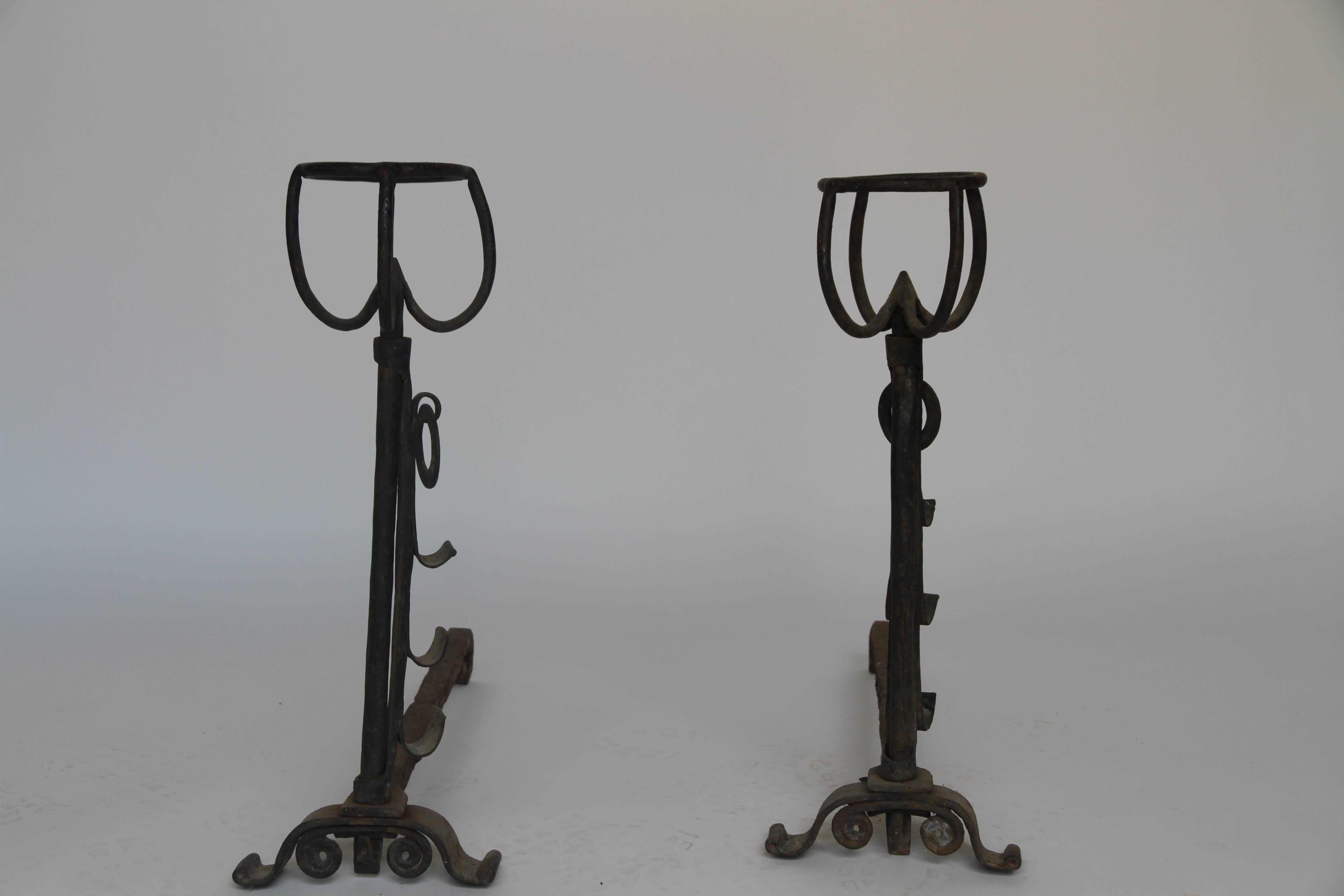 French Gothic andirons or fire dogs made of wrought iron. These French andirons are called 'landiers' in France. This dates from the times the andirons were the main cooking equipment in the house. They had spit hooks to grill meat or poultry and
