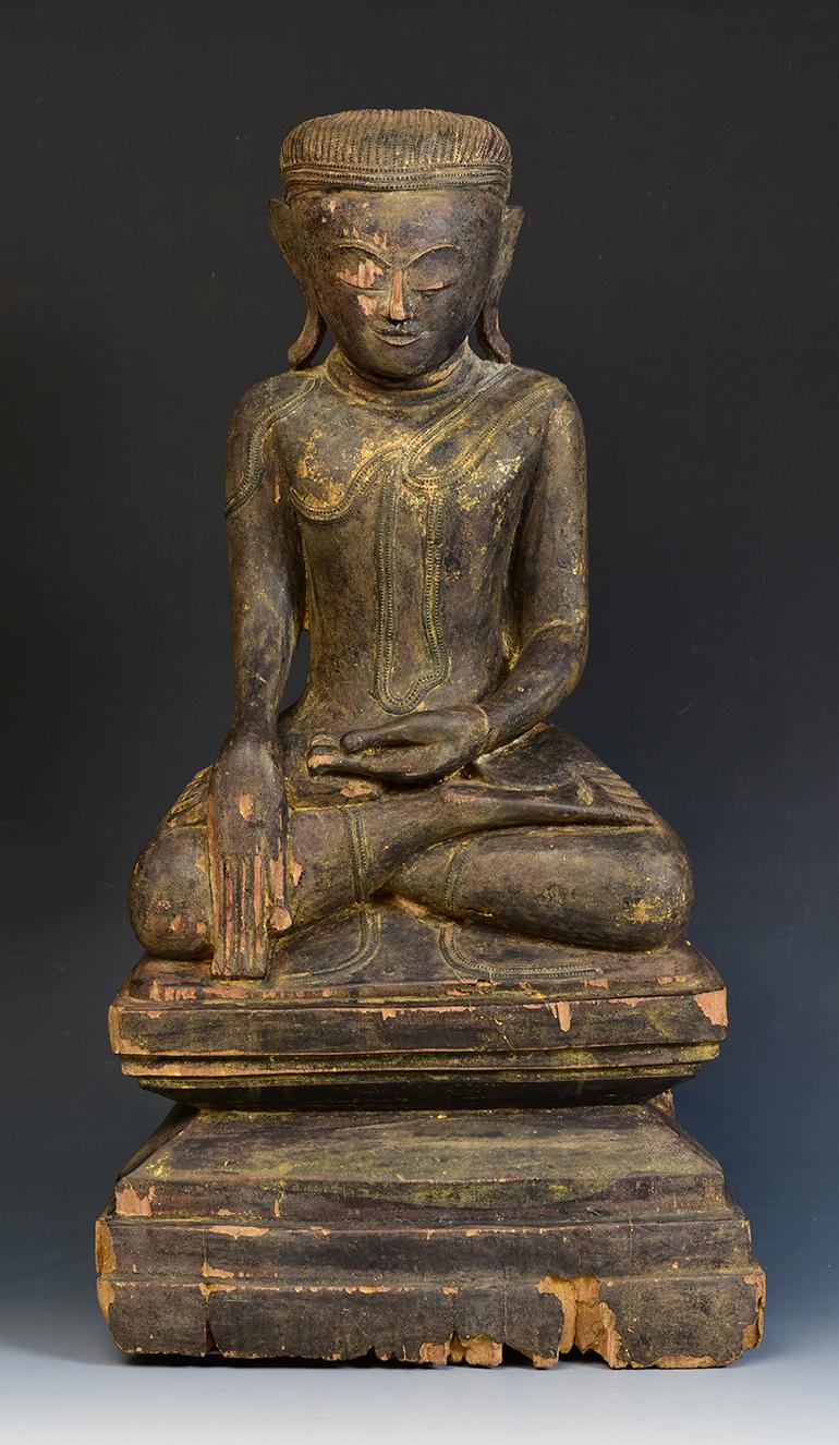 Burmese wooden Buddha sitting in Mara Vijaya (calling the earth to witness) posture on a base.

Age: Burma, Shan Period, 17th - 18th century
Size: Height 52 C.M. / Width 27.7 C.M.
Condition: Nice condition overall (some expected degradation due