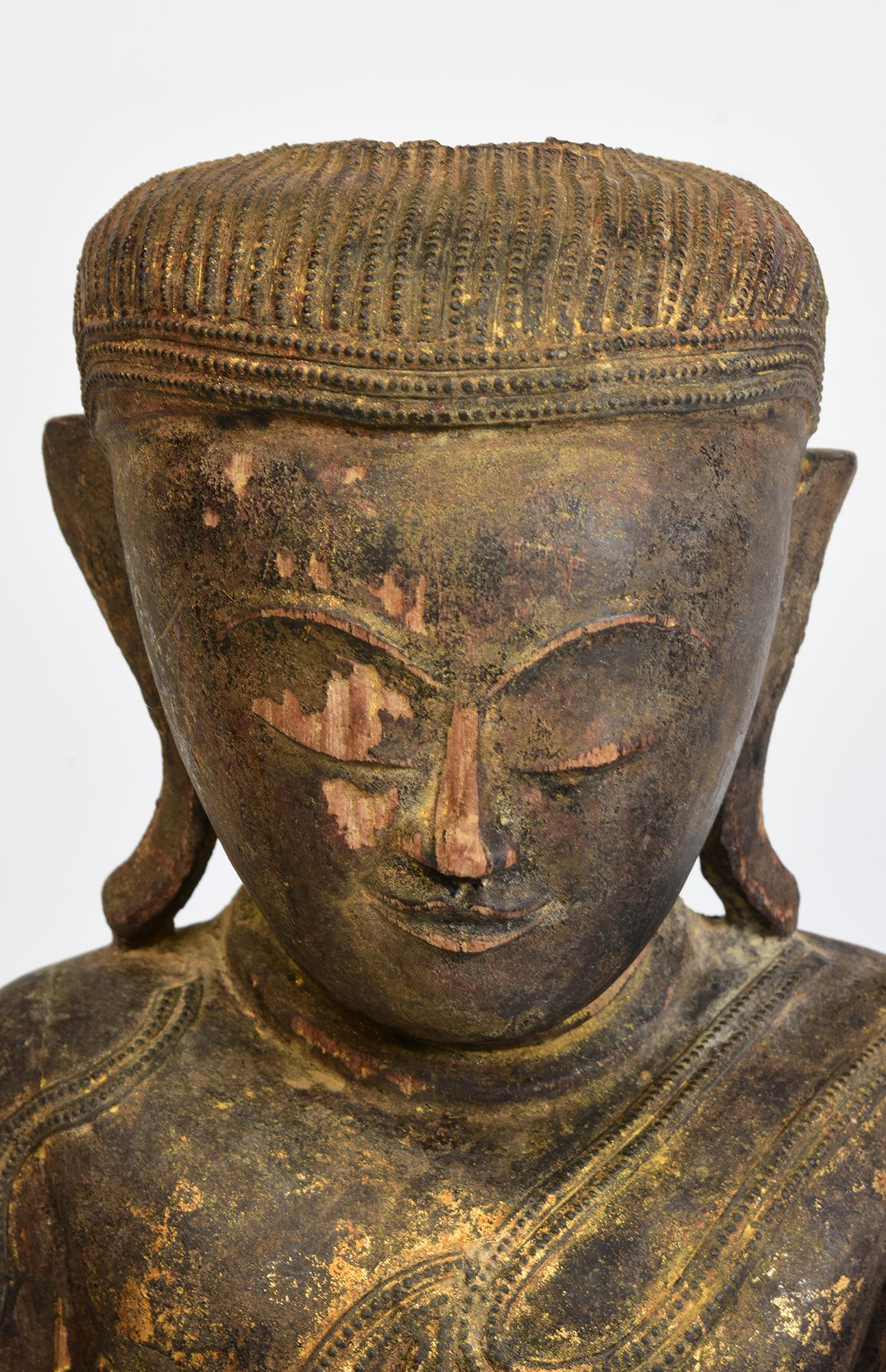 Antique Burmese wooden Buddha sitting in Mara Vijaya (calling the earth to witness) posture on a base.

Age: Burma, Shan Period, 17th - 18th Century
Size: Height 52 C.M. / Width 27.7 C.M. / Depth 11 C.M.
Condition: Nice condition overall (some