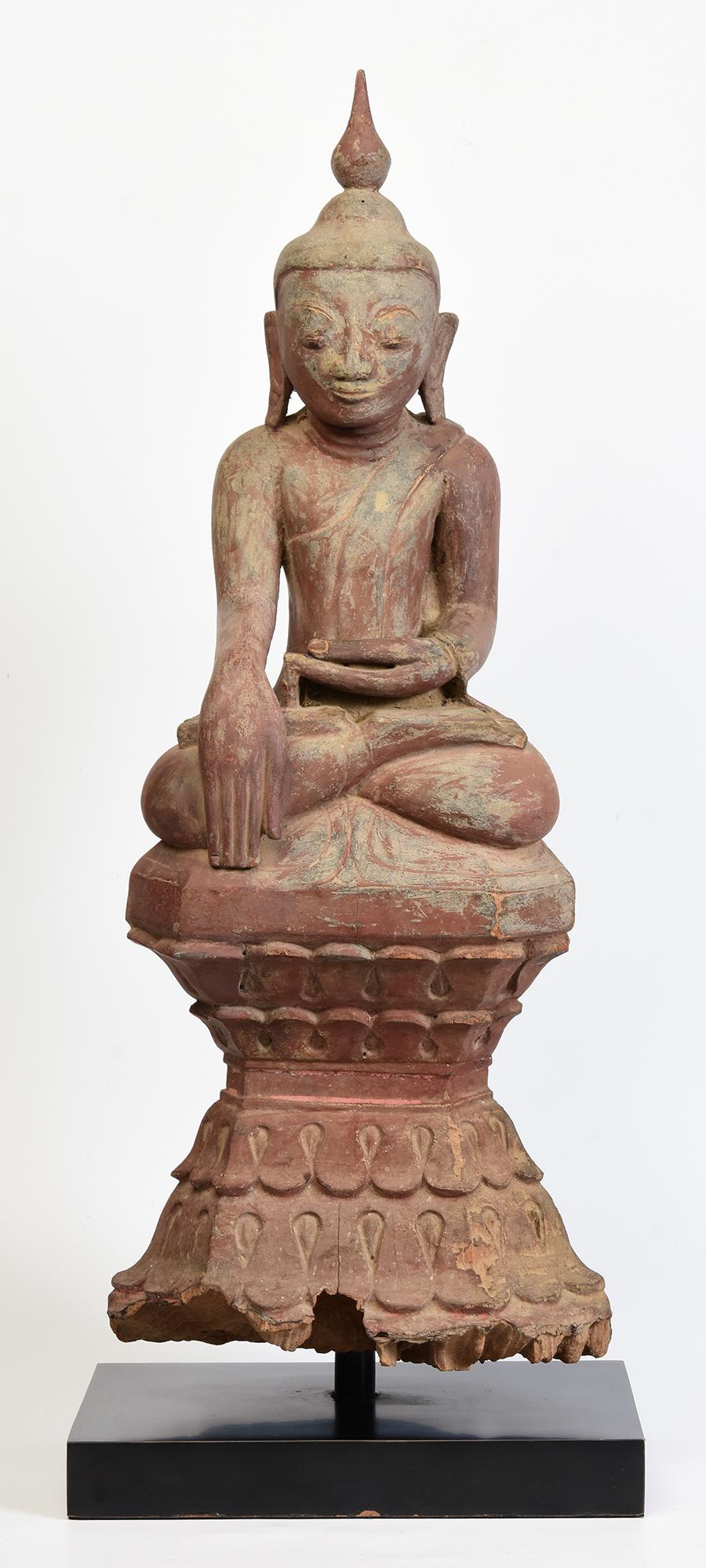 Antique Burmese wooden Buddha sitting in Mara Vijaya (calling the earth to witness) posture on a base.

Age: Burma, Shan Period, 17th - 18th Century
Size of Buddha only: Height 64 C.M. / Width 25 C.M. / Depth 14.3 C.M.
Height including stand: 69.8