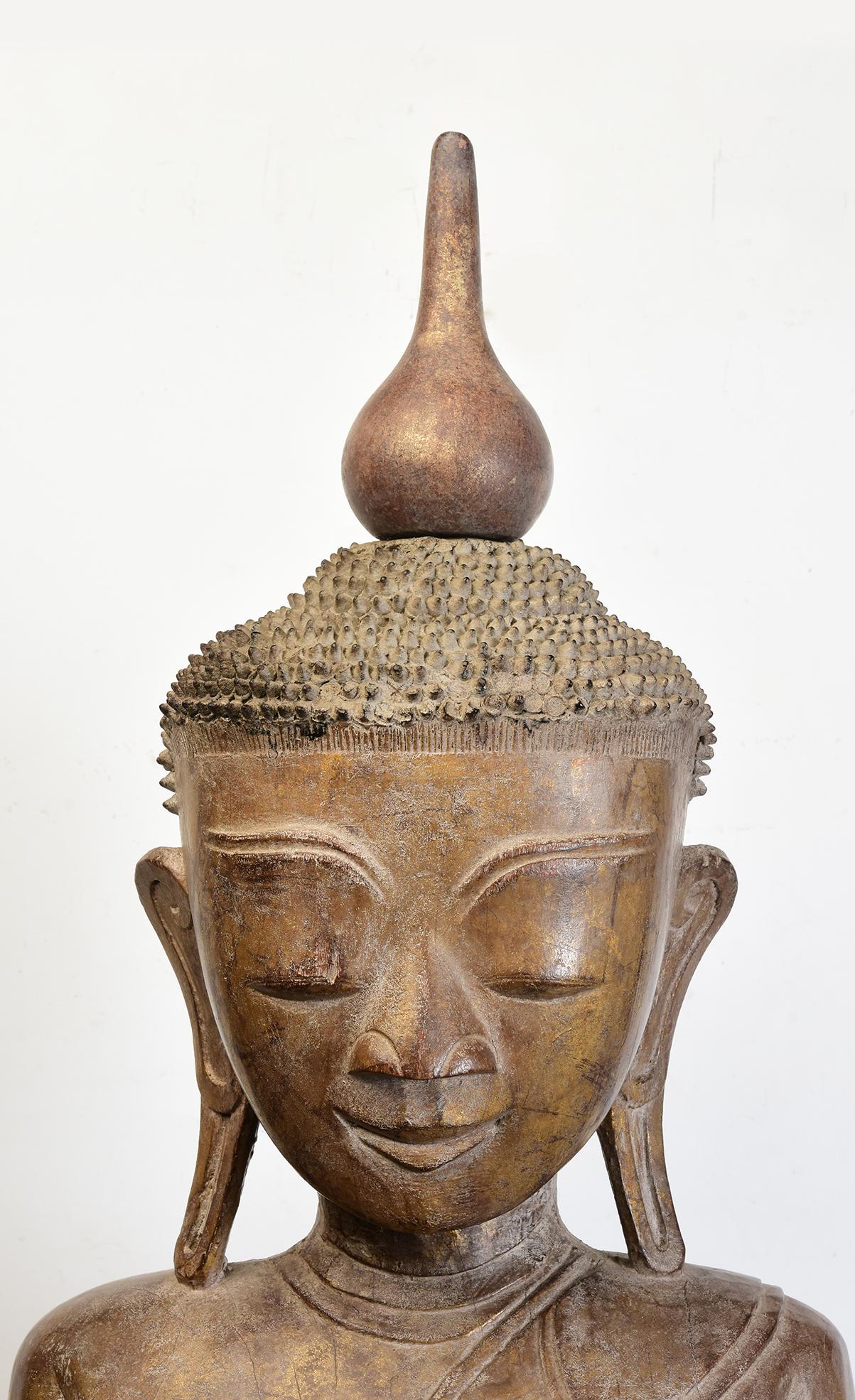 Antique Burmese wooden Buddha sitting in Mara Vijaya (calling the earth to witness) posture on a base.

The top of Buddha head is detachable.

Age: Burma, Shan Period, 17th - 18th Century
Size: Height 106.5 C.M. / Width 47 C.M. / Depth 25.5