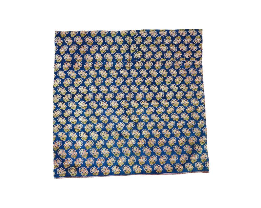 An antique Persian Safavid dynasty hand woven textile. The front side is decorated with flowers and birds on a blue background, while the reverse side features a floral motif on a red background. Circa: 17th century. Safavid Iran or Safavid Persia,