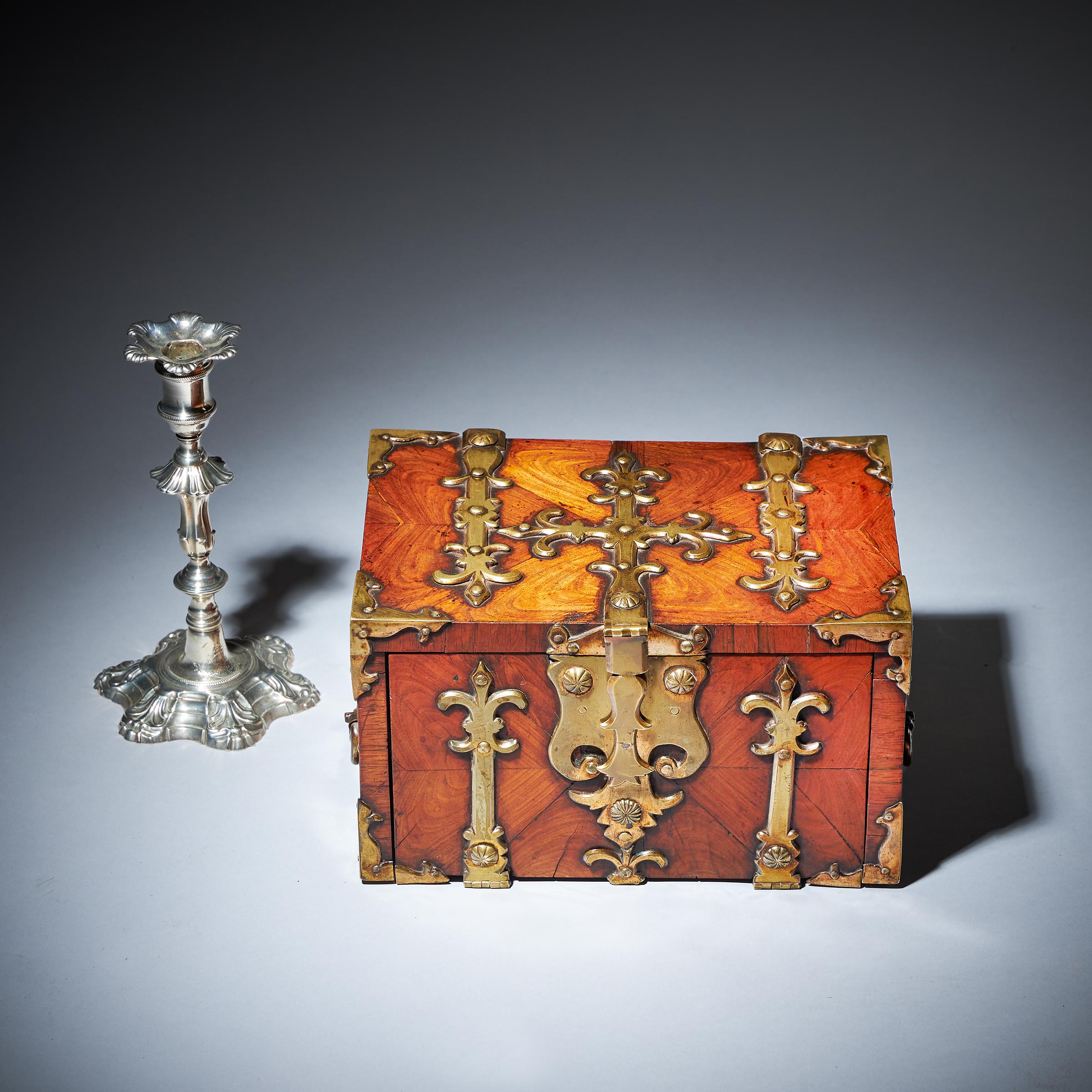 A William and Mary Kingwood / Princes Oyster Strongbox or Coffre Fort of Diminutive Proportions, Circa 1680-1700, England. 

Adorned with highly decorative gilt brass strapwork and decorated entirely in knife cut oysters of kingwood, this box is fit